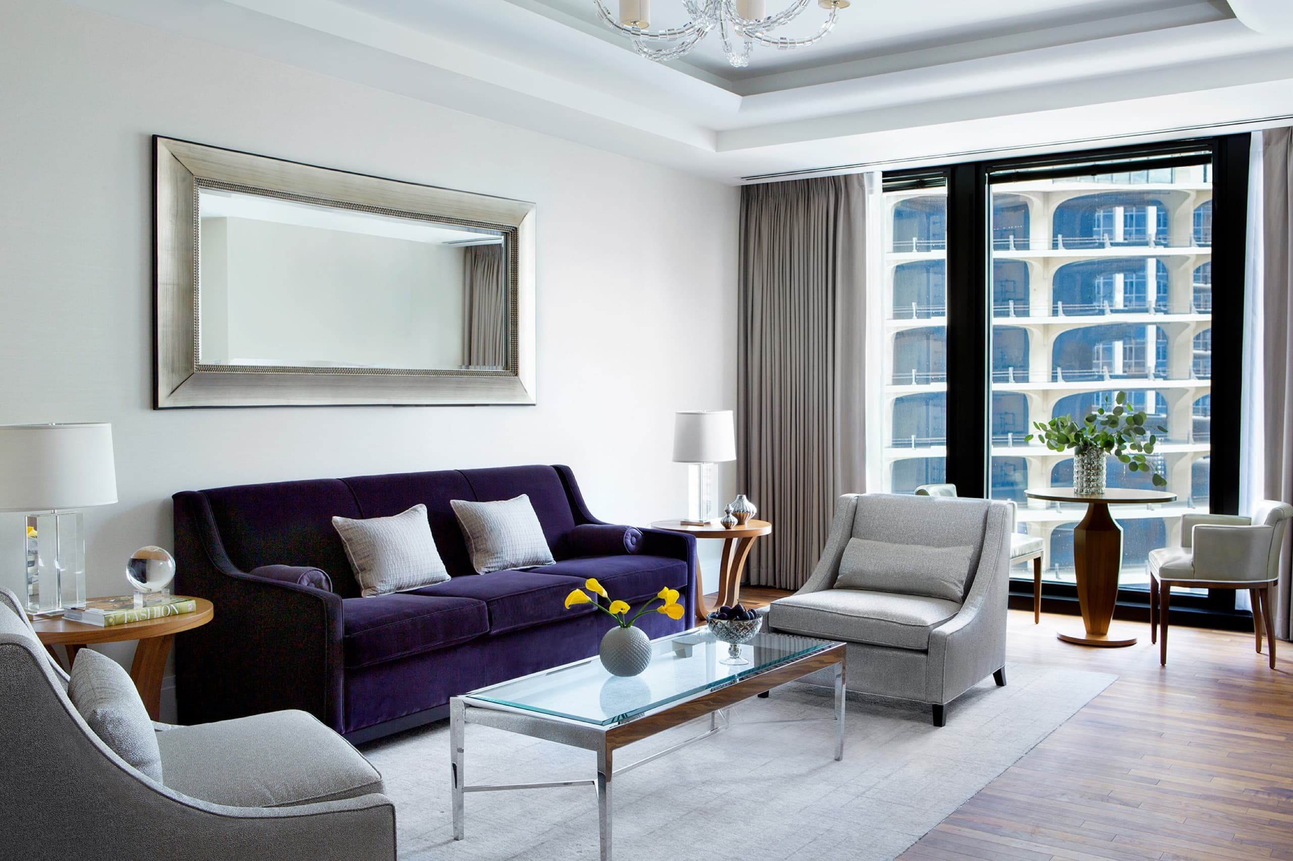 One Bedroom River View Suite — living room at dusk with illuminated skyline