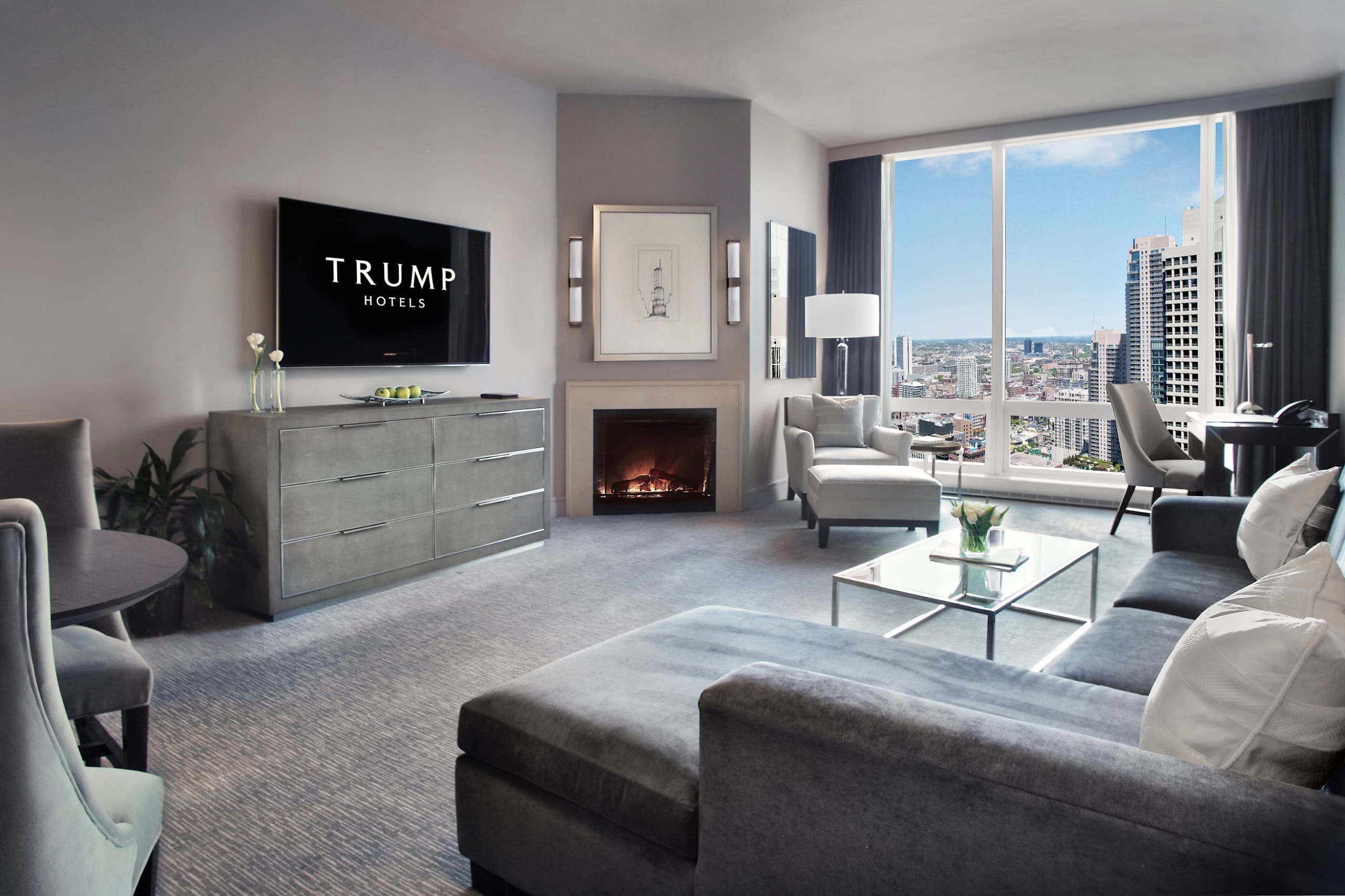 Deluxe City View One-Bedroom Suite living room with fireplace and city windows