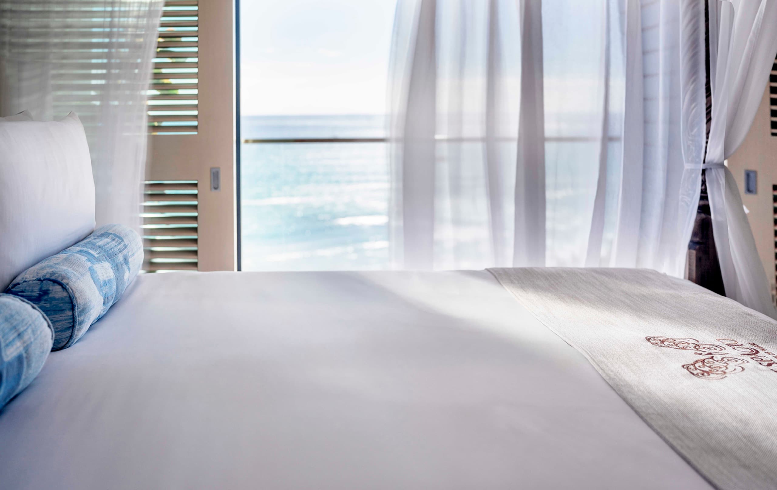 Primary bedroom - canopy king bed opening onto the private balcony and ocean