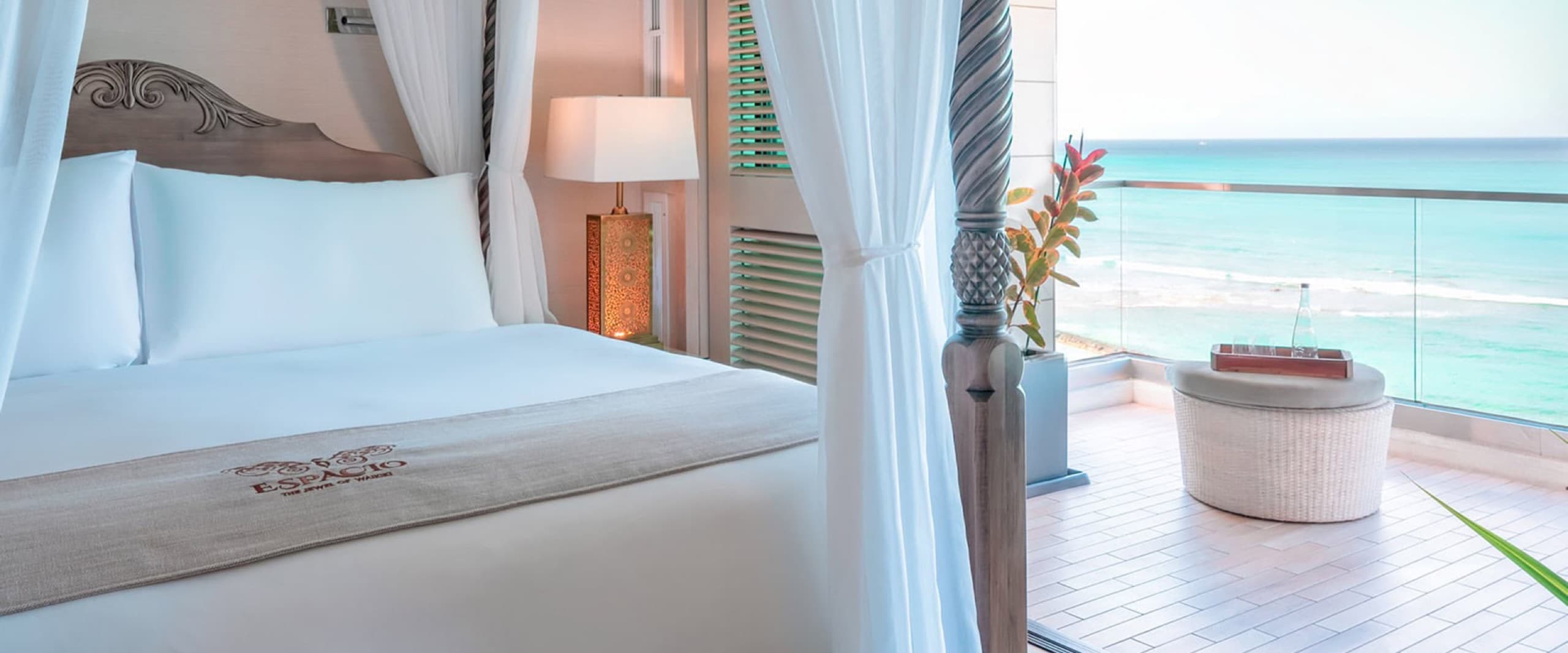 Penthouse Diamond Suite - king canopy bed beside the balcony with ocean view