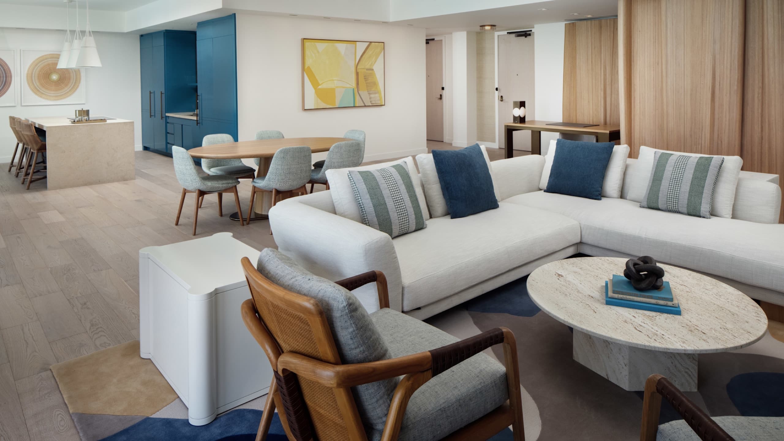 Chairman's Suite - living room with dining table and kitchen