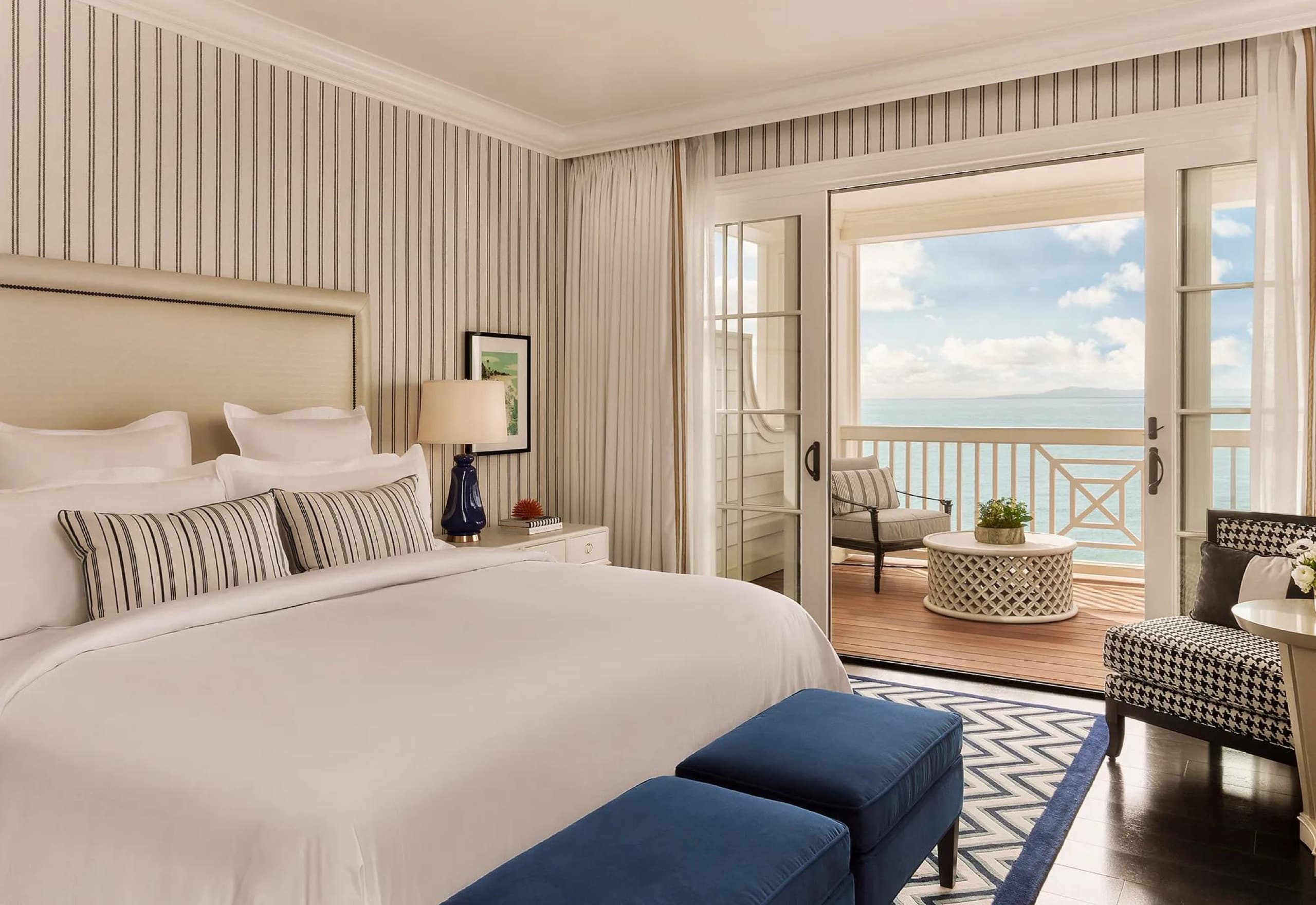 Beach House King guestroom opening onto an oceanfront terrace