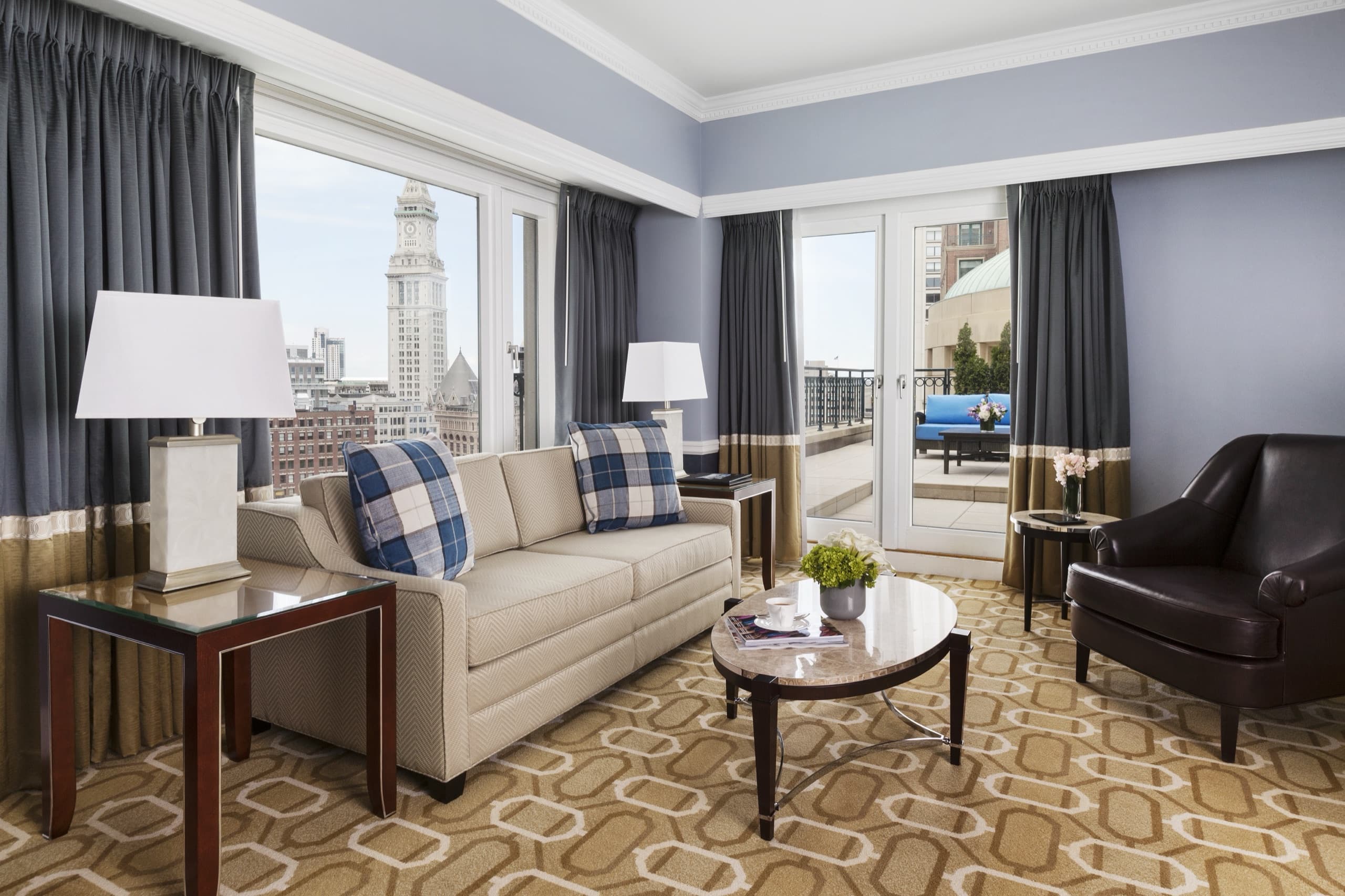 John Adams Presidential Suite: double-height living room with chandelier and harbor terrace