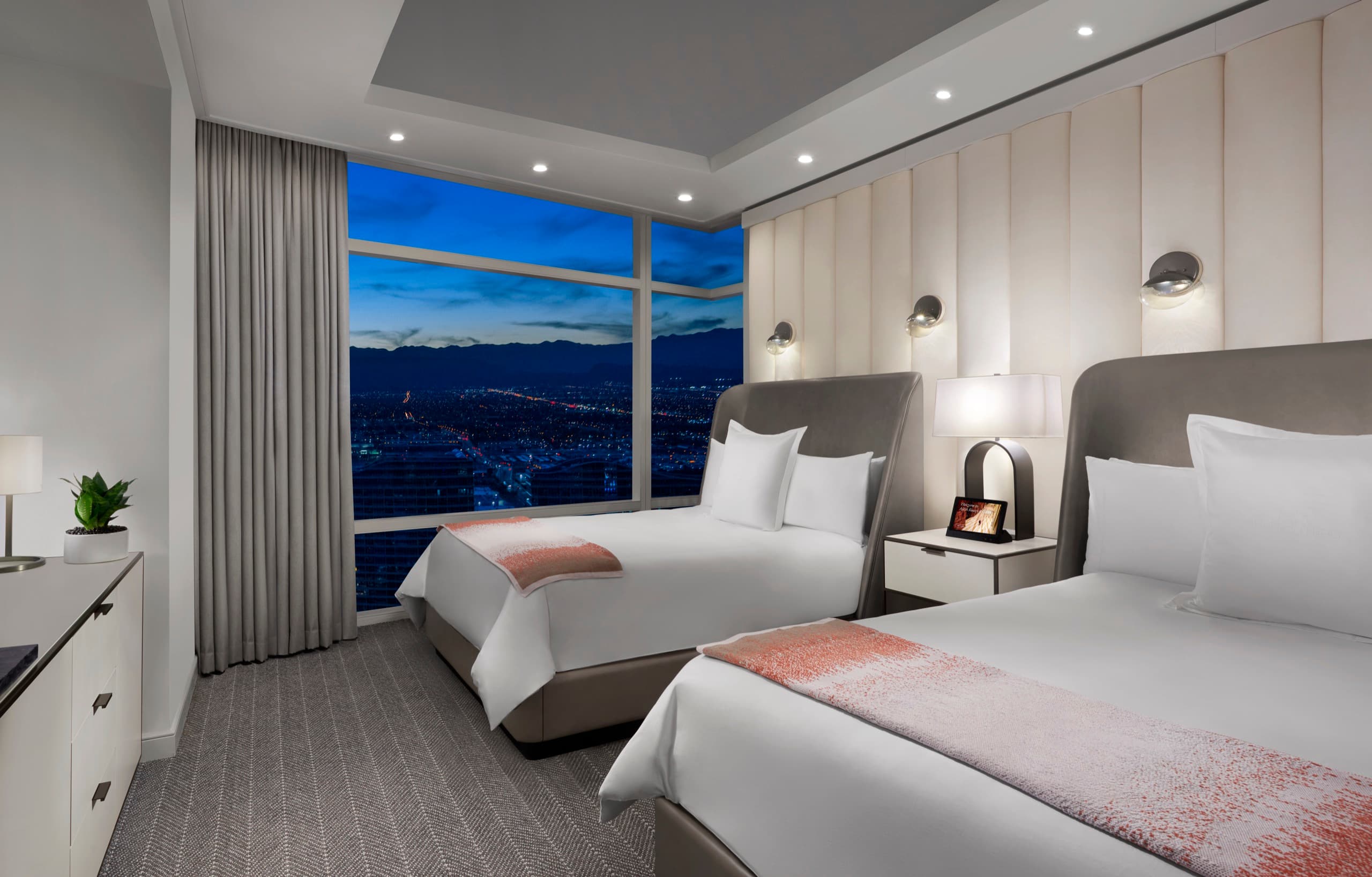 ARIA Sky Suite — bedroom with floor-to-ceiling Strip view at dusk