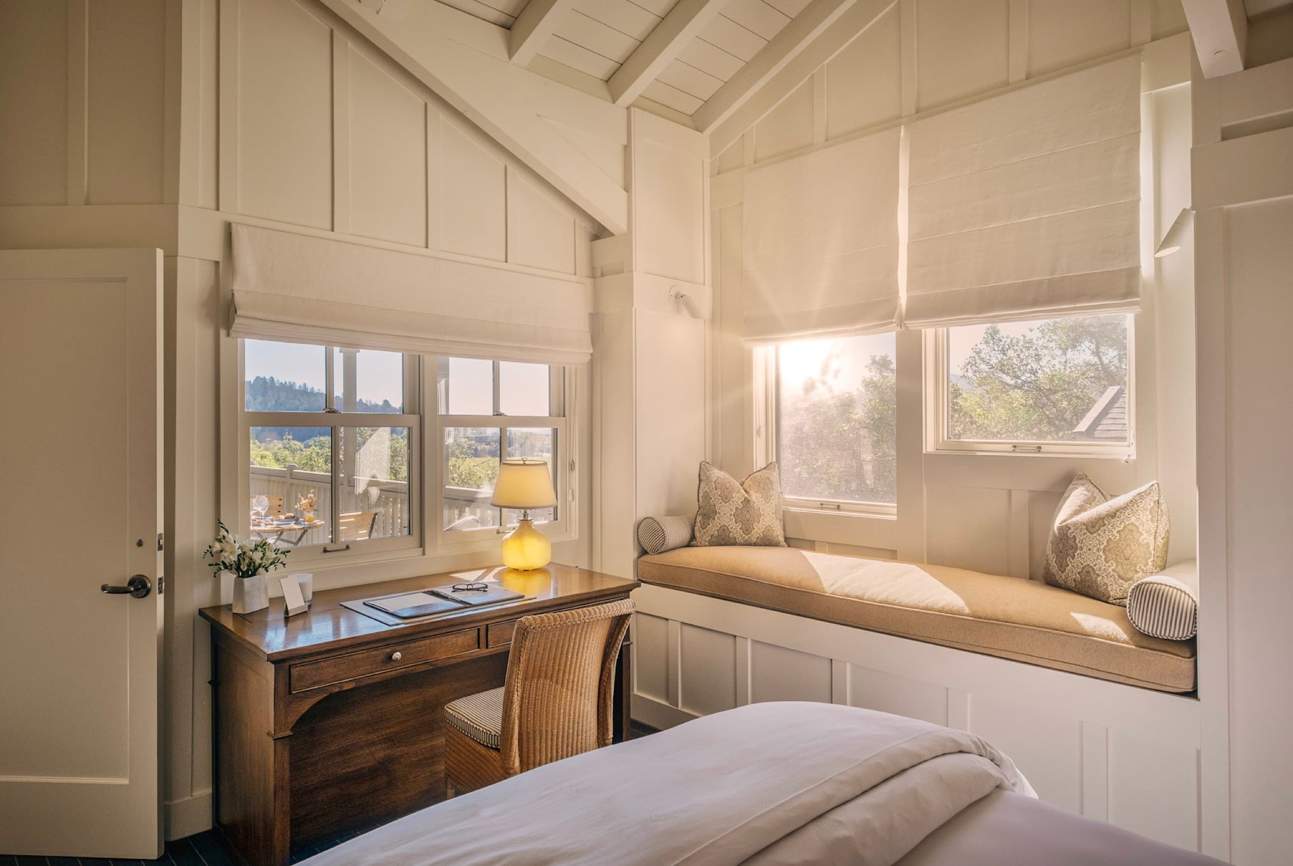 Treeline Suite living room with stone fireplace and treetop windows