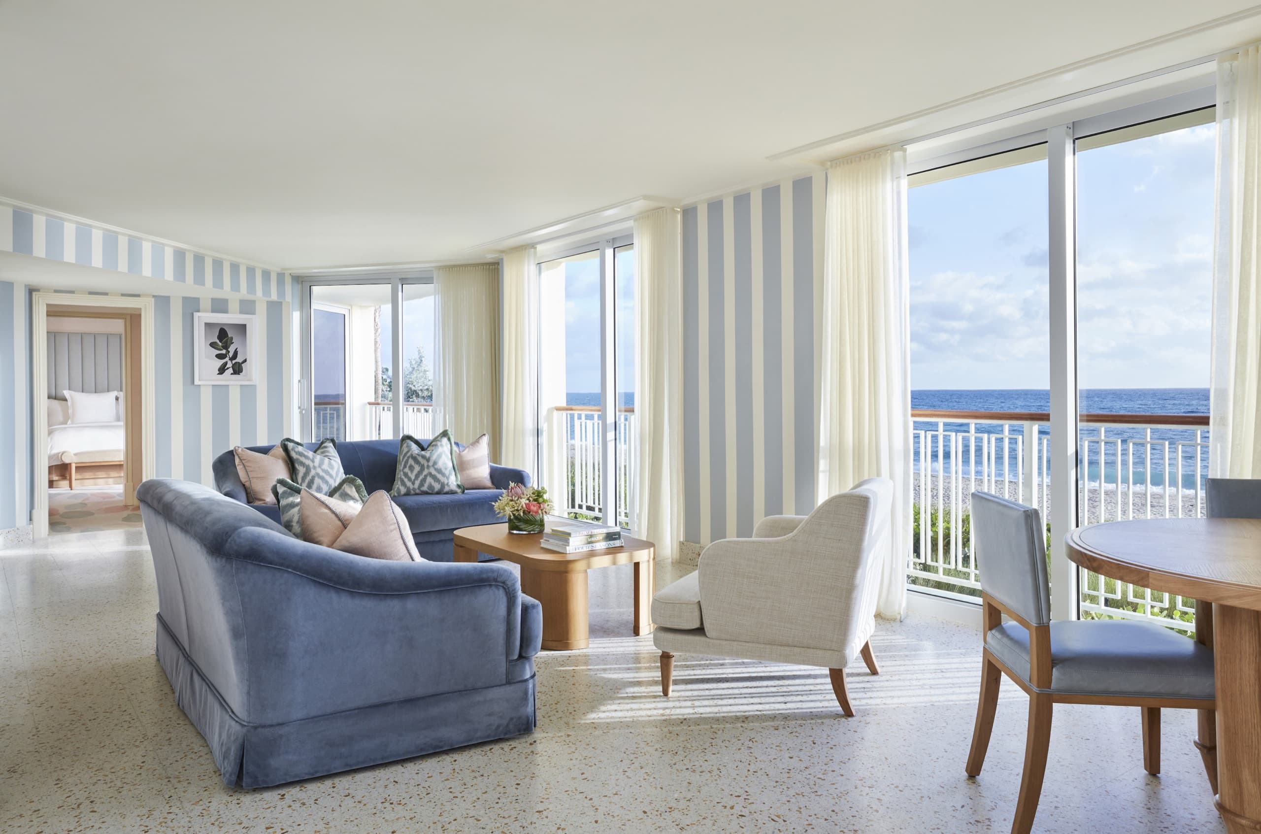 Sea Breeze Suite: living room with blue-striped walls, blue sofas and floor-to-ceiling ocean views