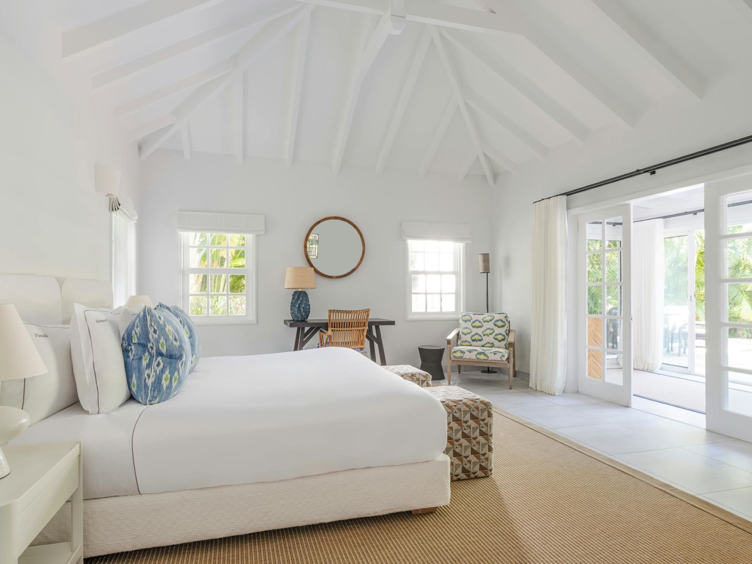 Garden Suite bedroom under the vaulted ceiling, opening to the private garden