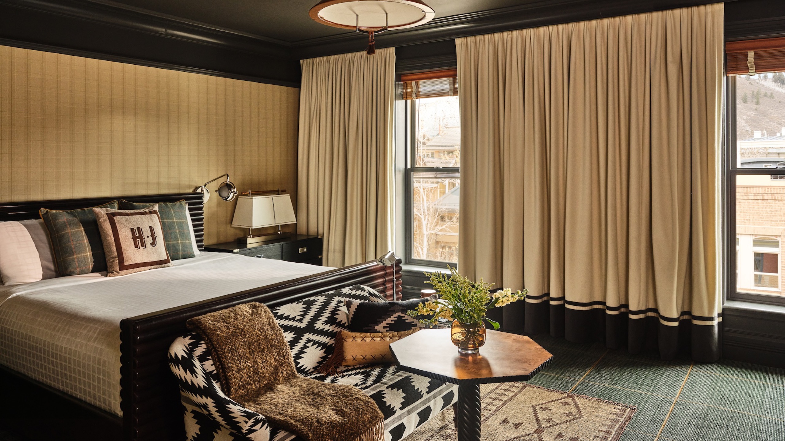 Deluxe King room with HJ monogram pillows and Aspen Mountain window