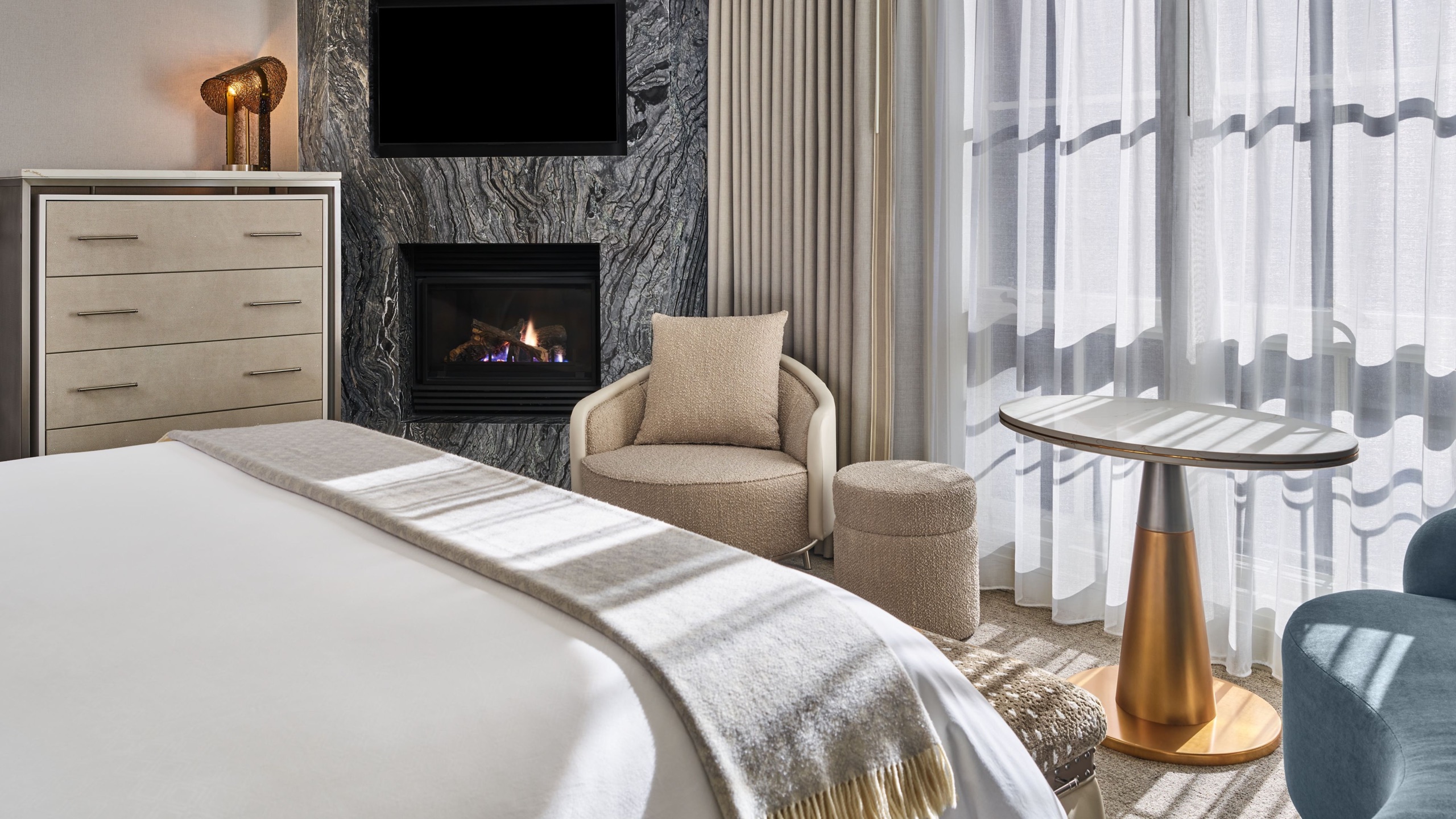 Deluxe With Fireplace, 1 King — bed facing the marble gas fireplace and lounge chair