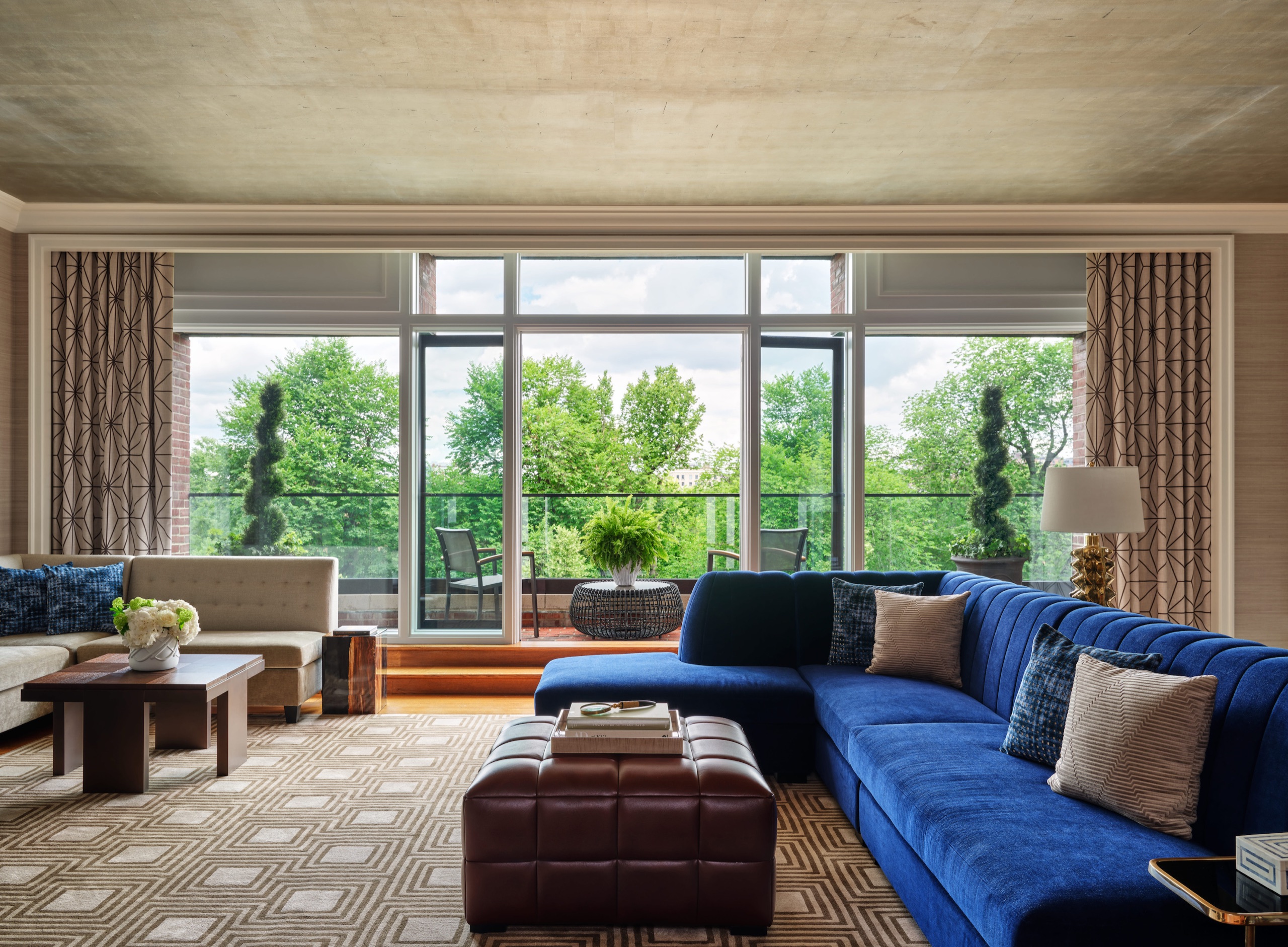 Royal Suite — living room with royal-blue velvet sofa, fireplace and bar