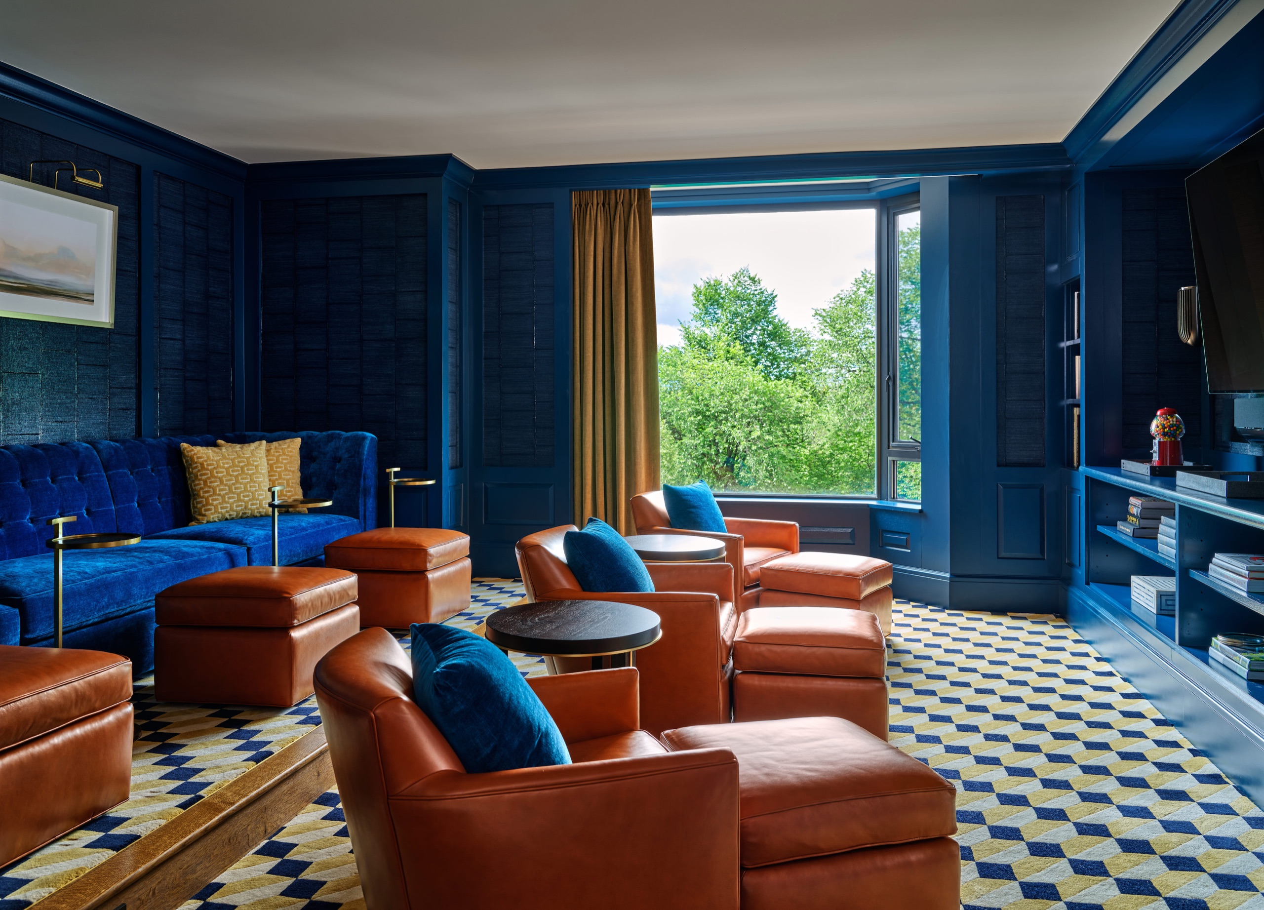 Royal Suite — king bedroom with blue-and-white rug and navy accents