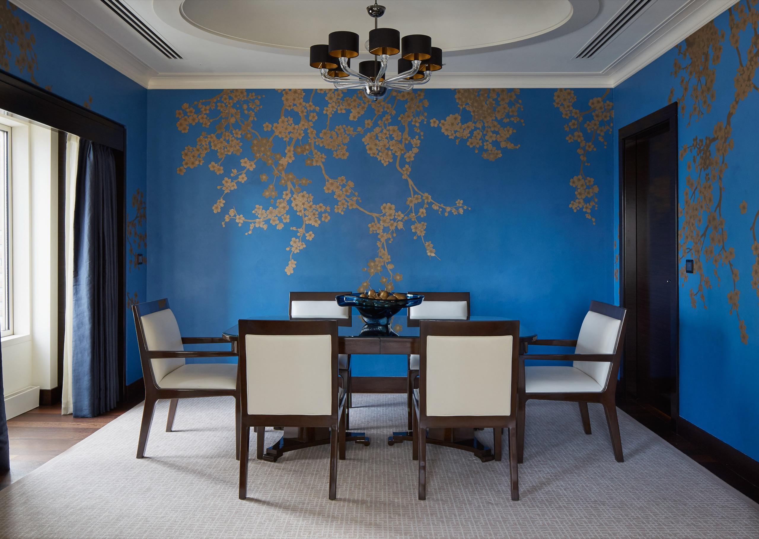 Lake Suite, living room with blue velvet chairs (hero image on the official Lake Suite page)