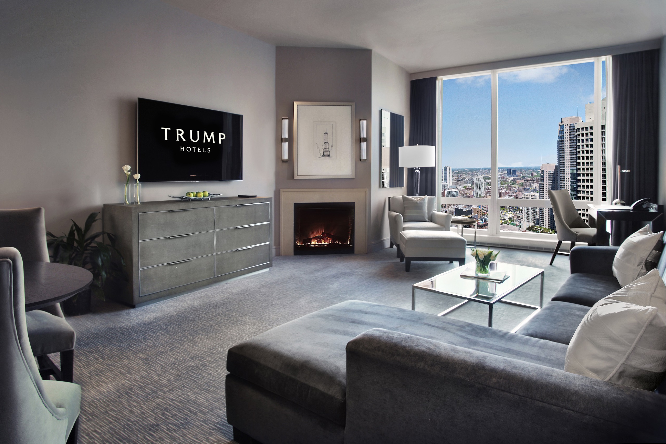 Deluxe City View One-Bedroom Suite living room with fireplace and city windows