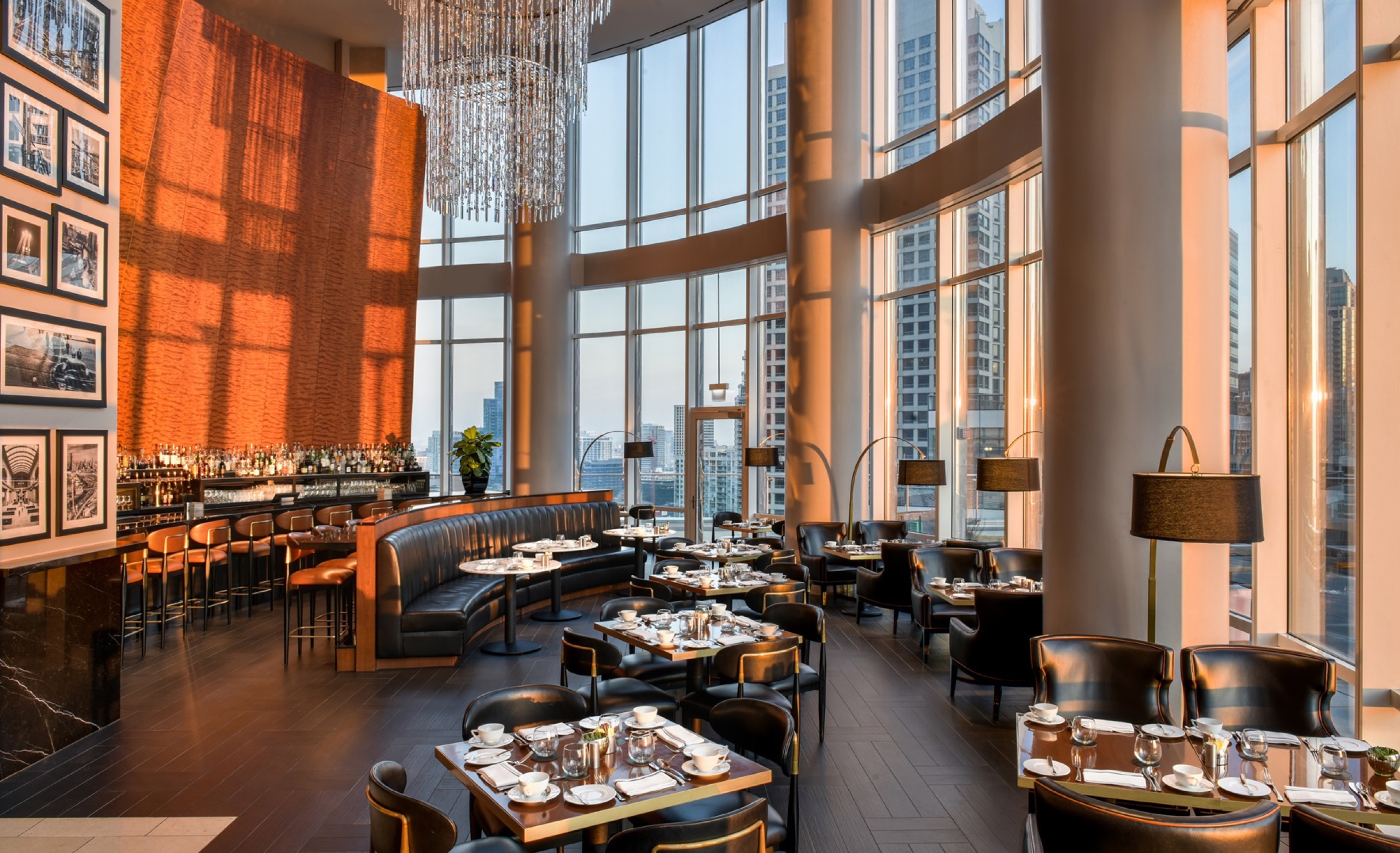 Terrace 16 dining room at golden hour, double-height windows