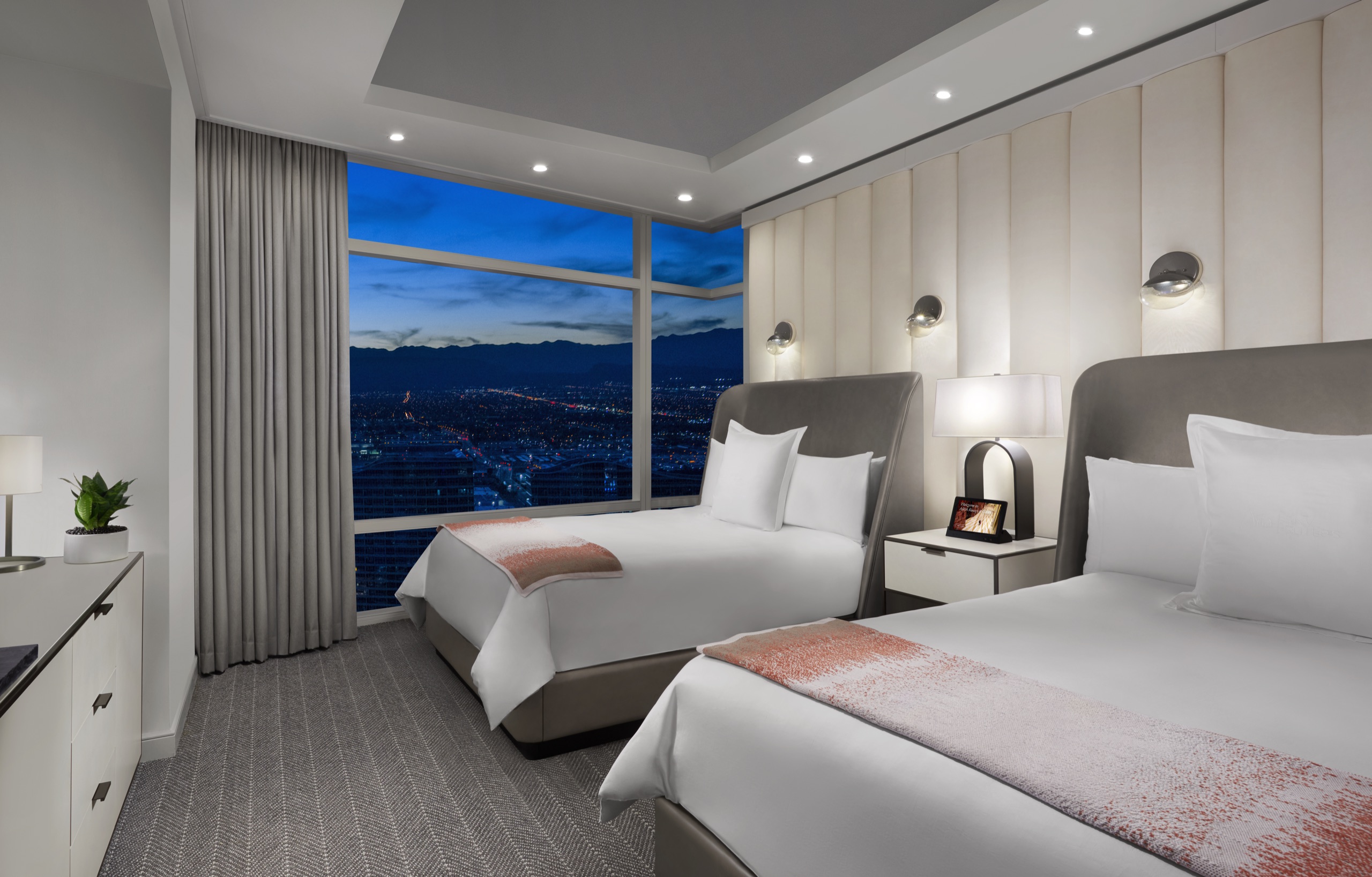 ARIA Sky Suite — bedroom with floor-to-ceiling Strip view at dusk