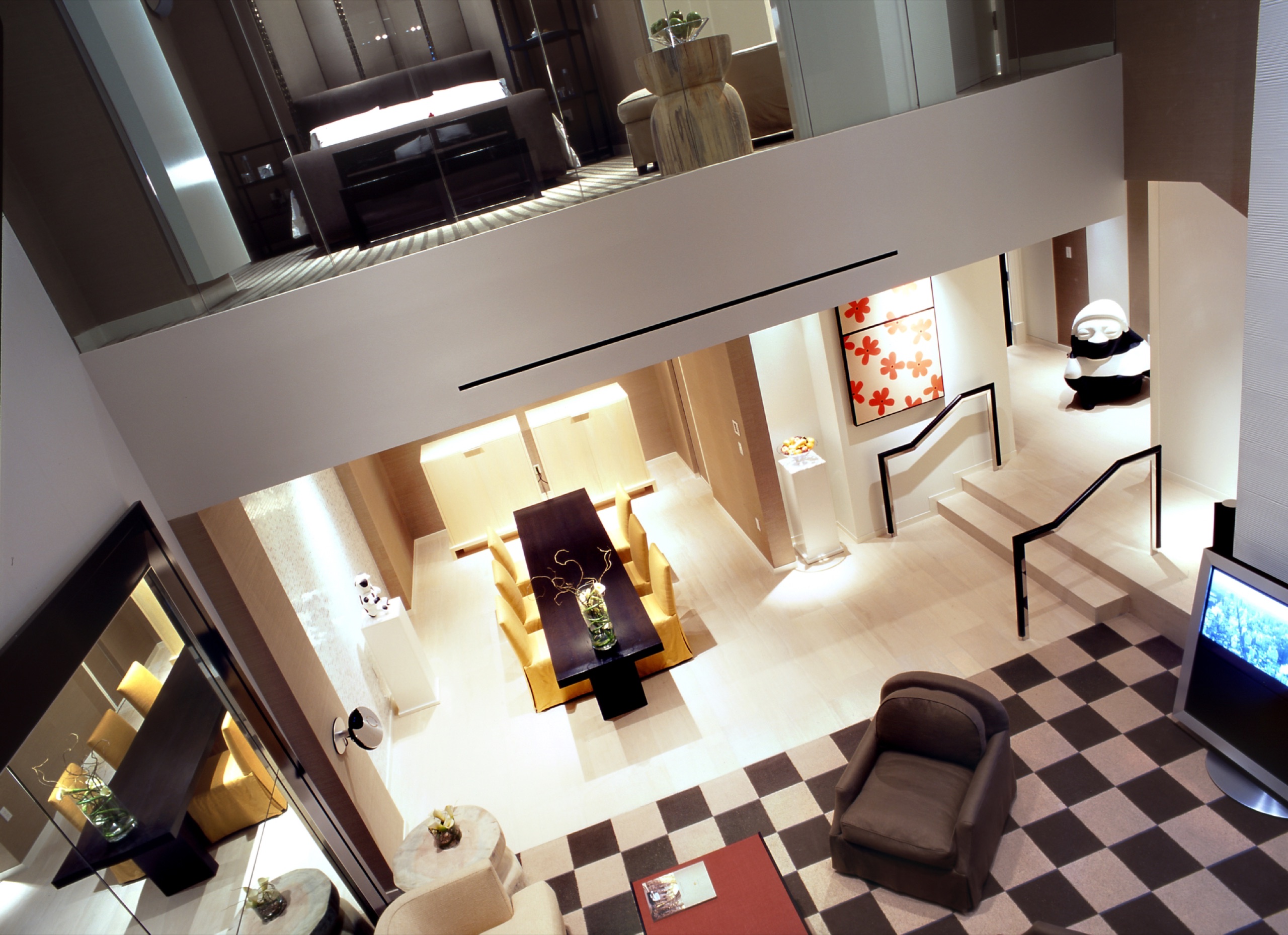 One Bedroom Loft two-story living and dining room from the mezzanine