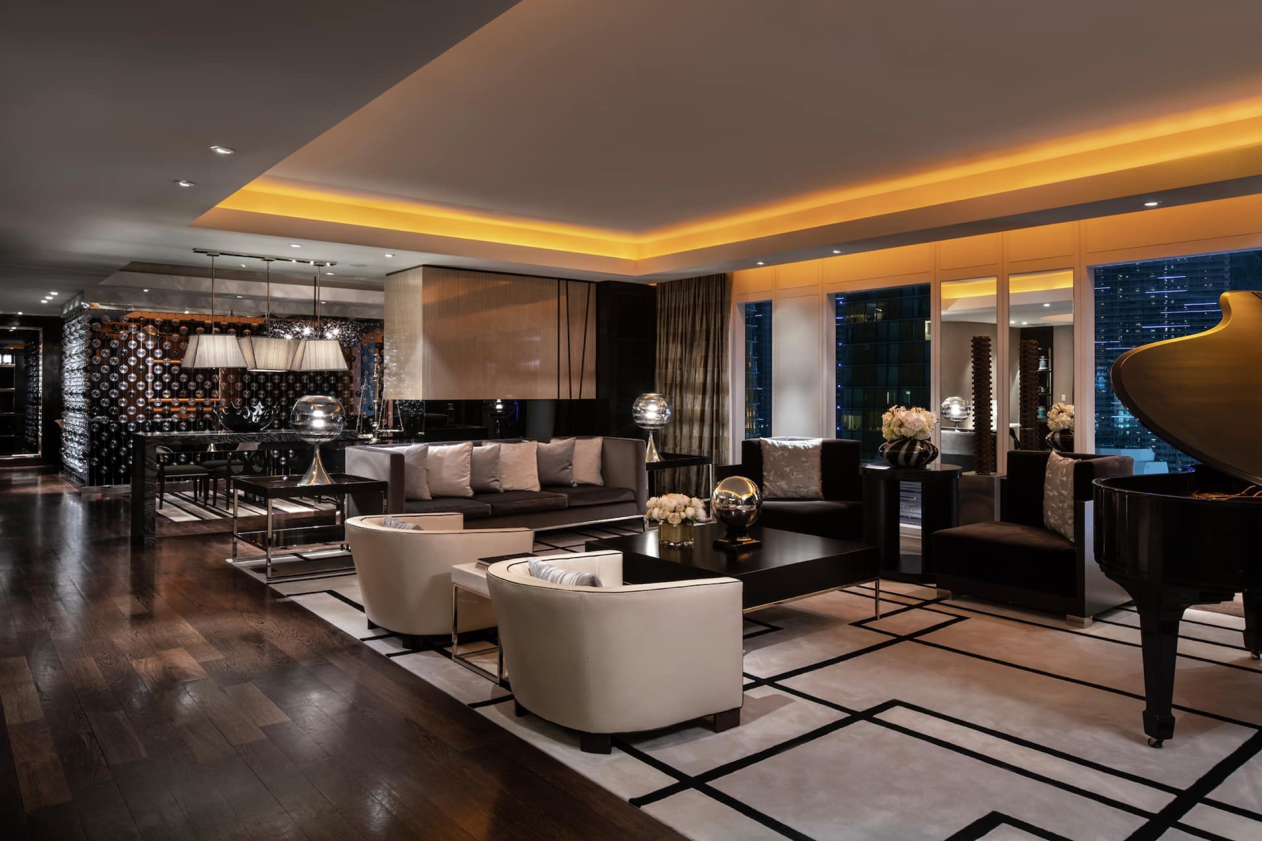 Presidential Suite - living room with grand piano, private bar and Strip windows