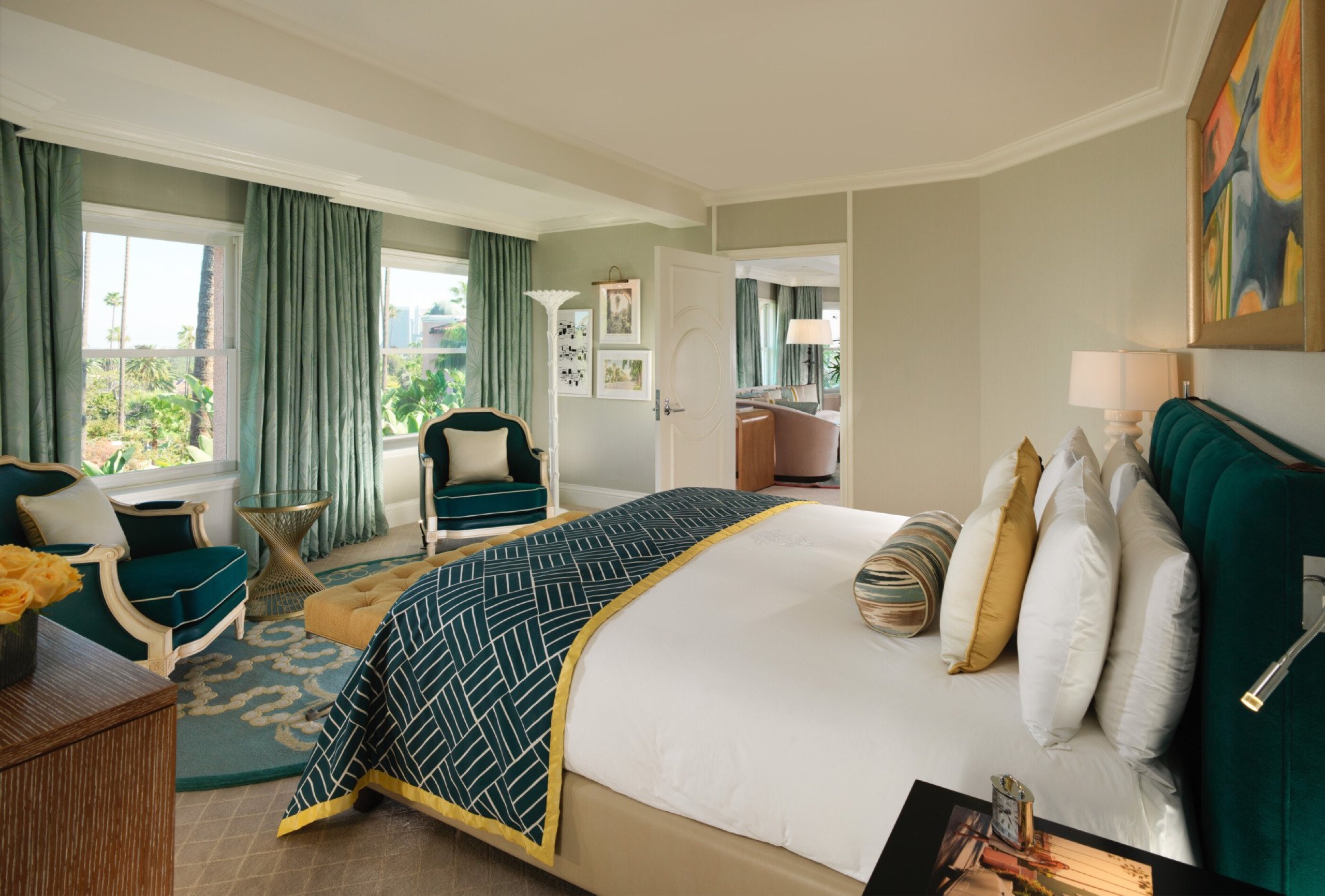 Suite with Balcony (Suite 418) — living room with curved sofa and palm-view windows