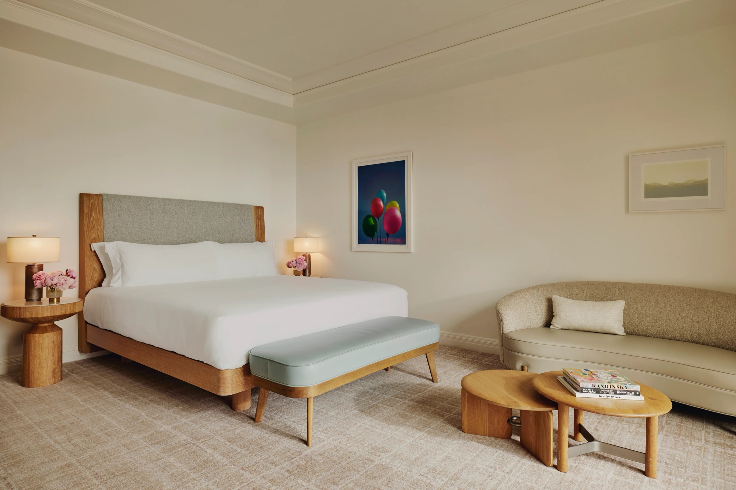 Balcony Room - king bed, curved sofa and cocktail table (520 sq ft)