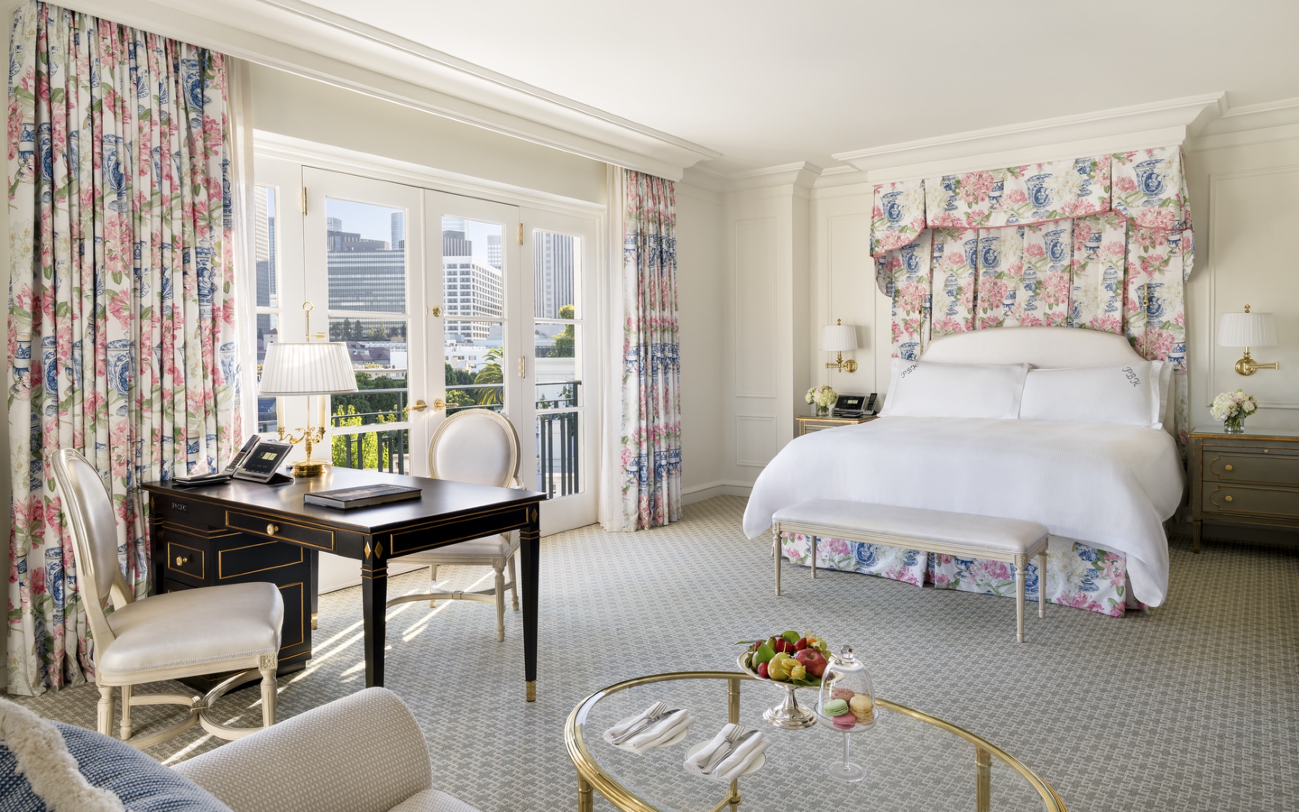 Premium Grand Deluxe Room - king bed under floral canopy, desk and balcony doors framing the Century City skyline (2025 redesign)