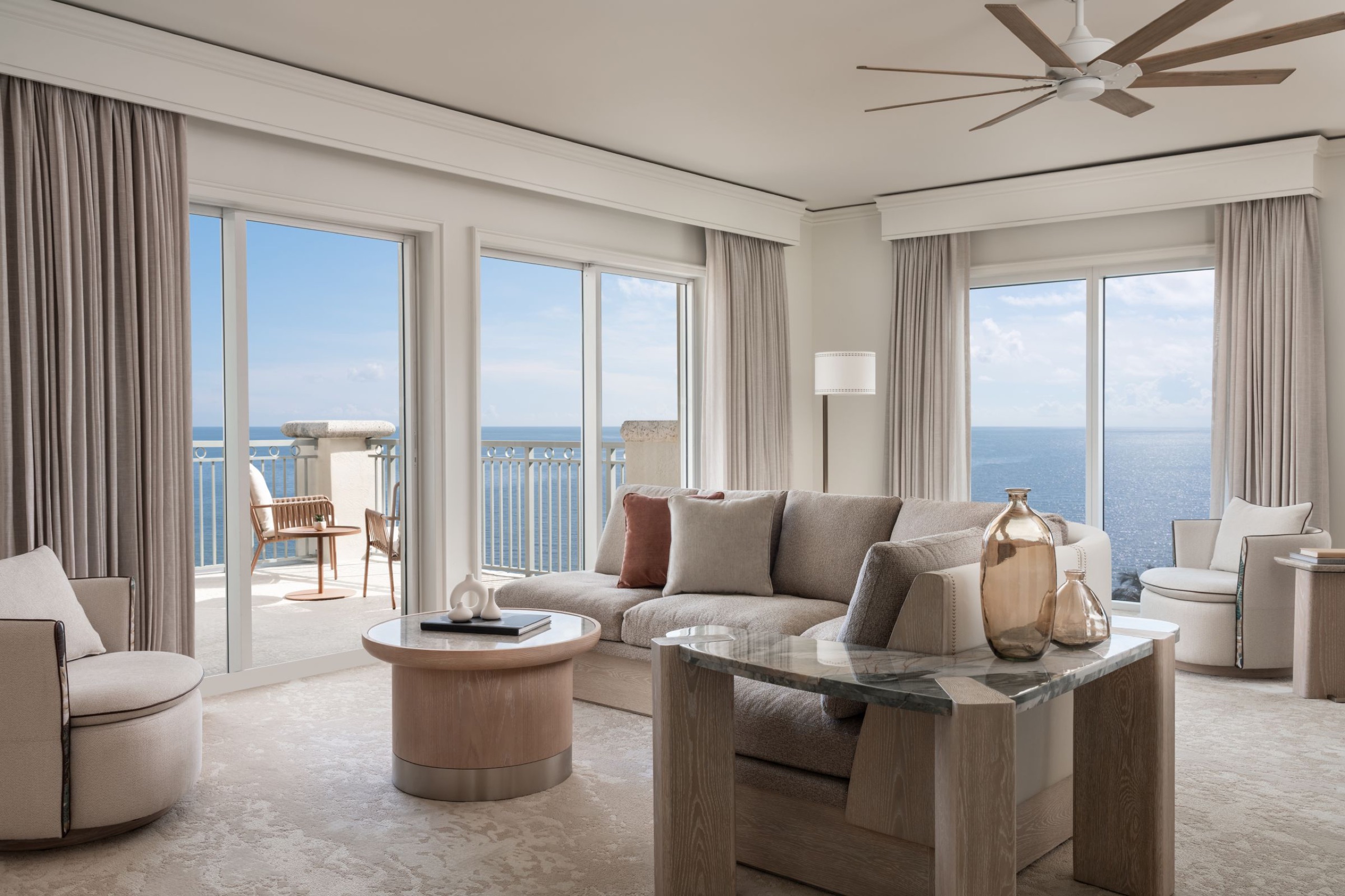 The Ritz-Carlton Suite: corner living room with dual ocean-view balconies