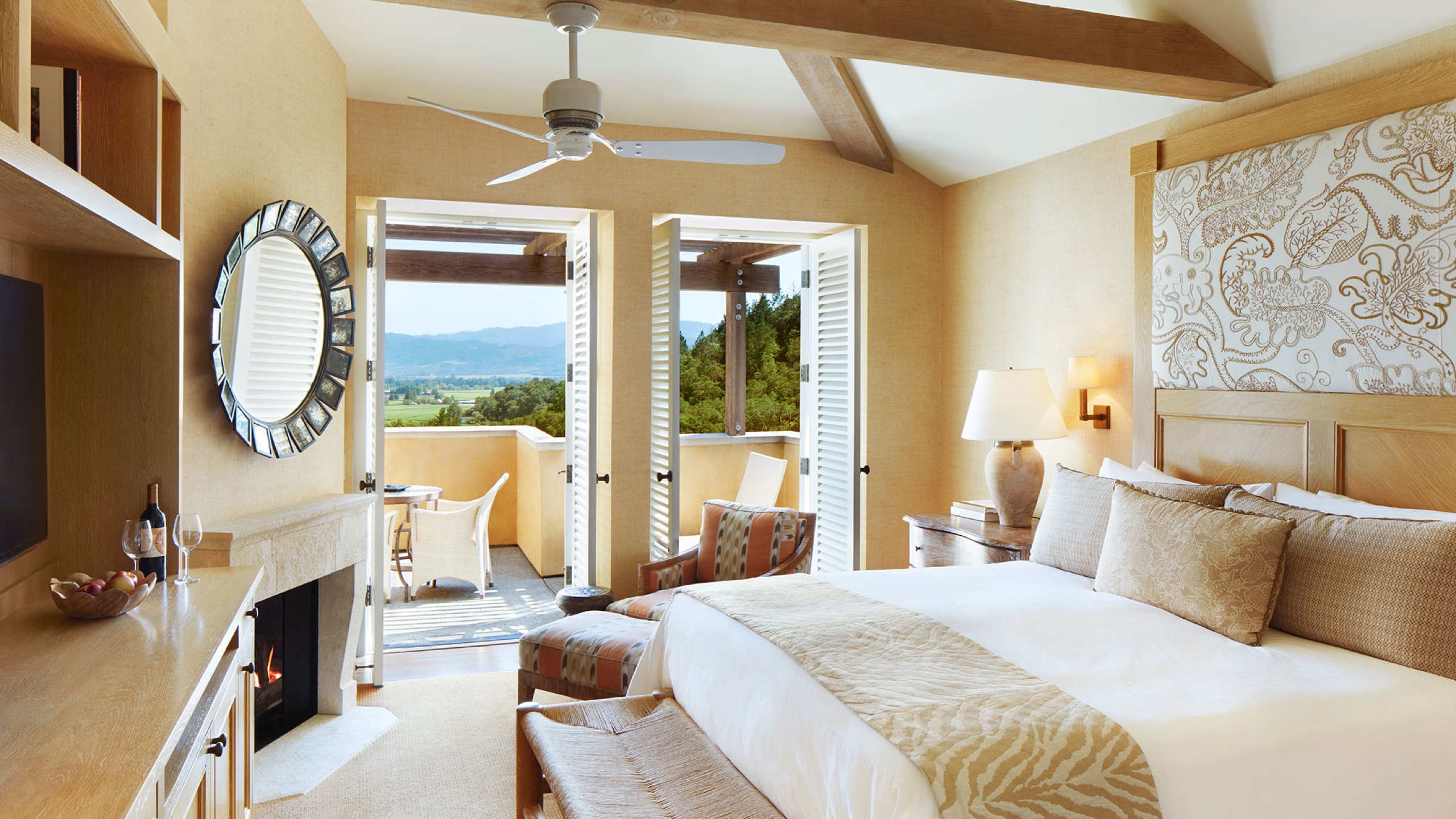 Deluxe Room bedroom opening to a private terrace with valley view