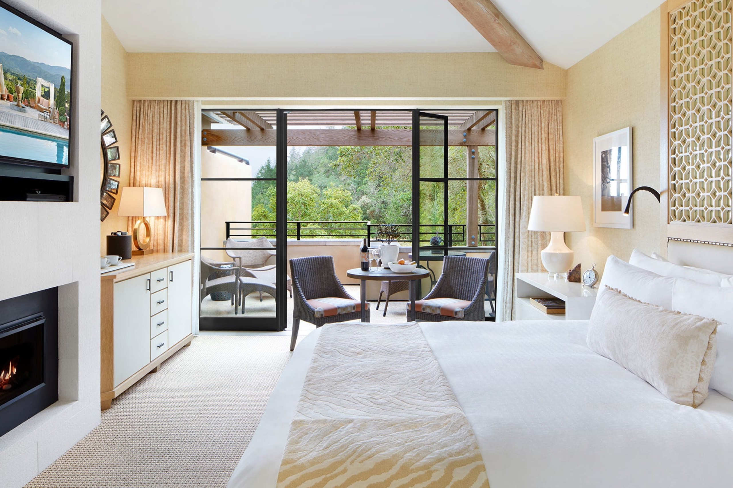 Deluxe Garden View Room with fireplace and terrace seating under the pergola