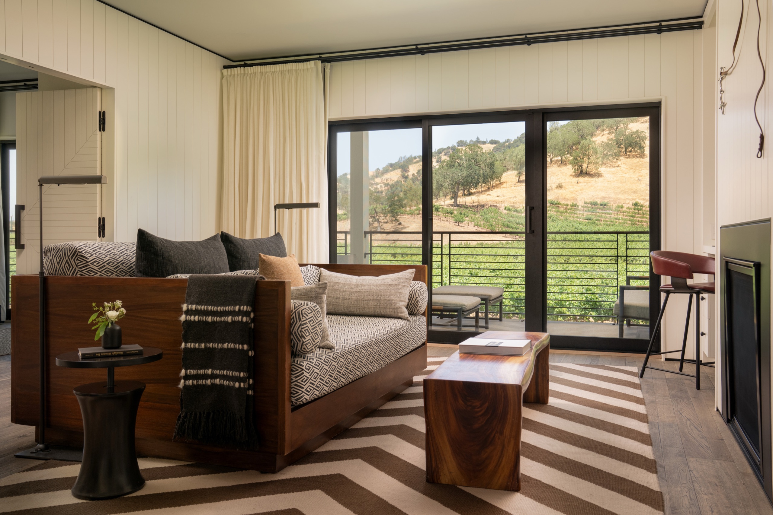 Vineyard & Palisades Mountain One-Bedroom Suite — living room with chevron rug opening to the vineyard terrace