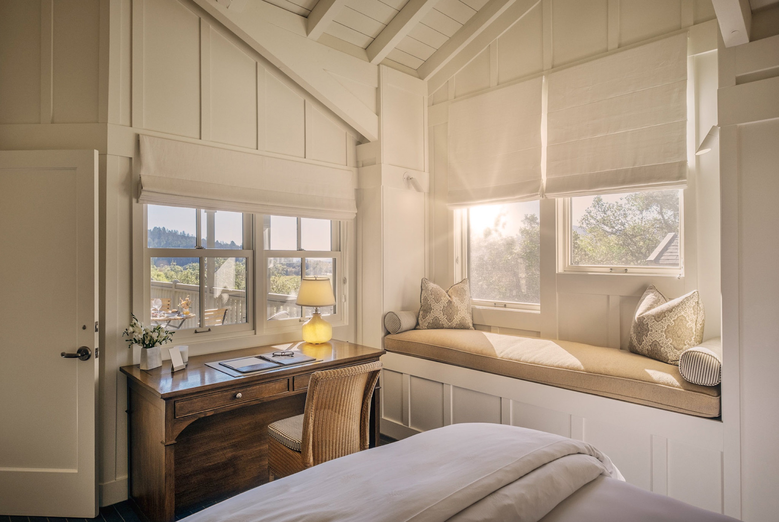 Treeline Suite living room with stone fireplace and treetop windows