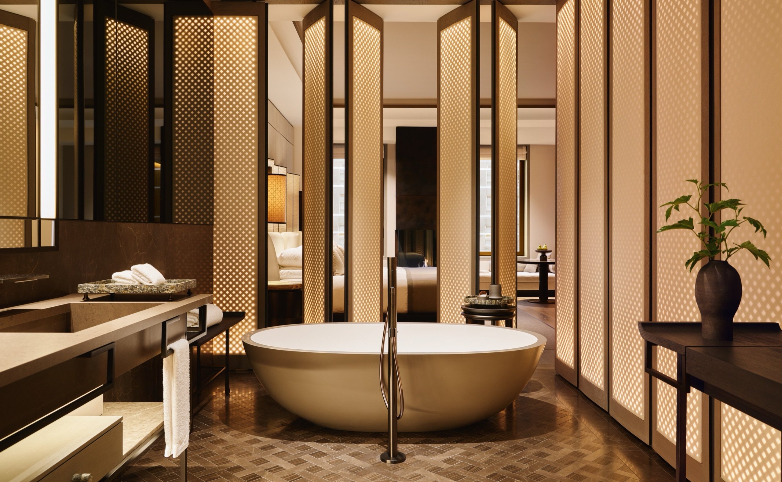 Fifth Avenue Junior Suite bathroom with freestanding tub behind lit lattice screens