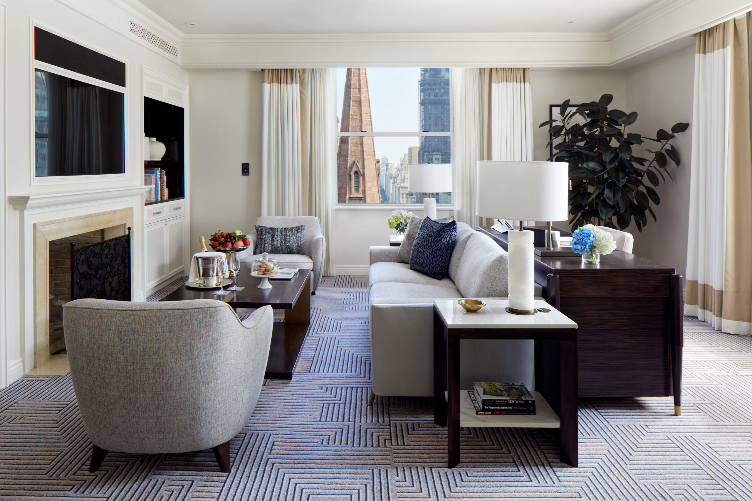 Corner one-bedroom suite living room with decorative fireplace and St Thomas Church spire view (2024 refurbishment)