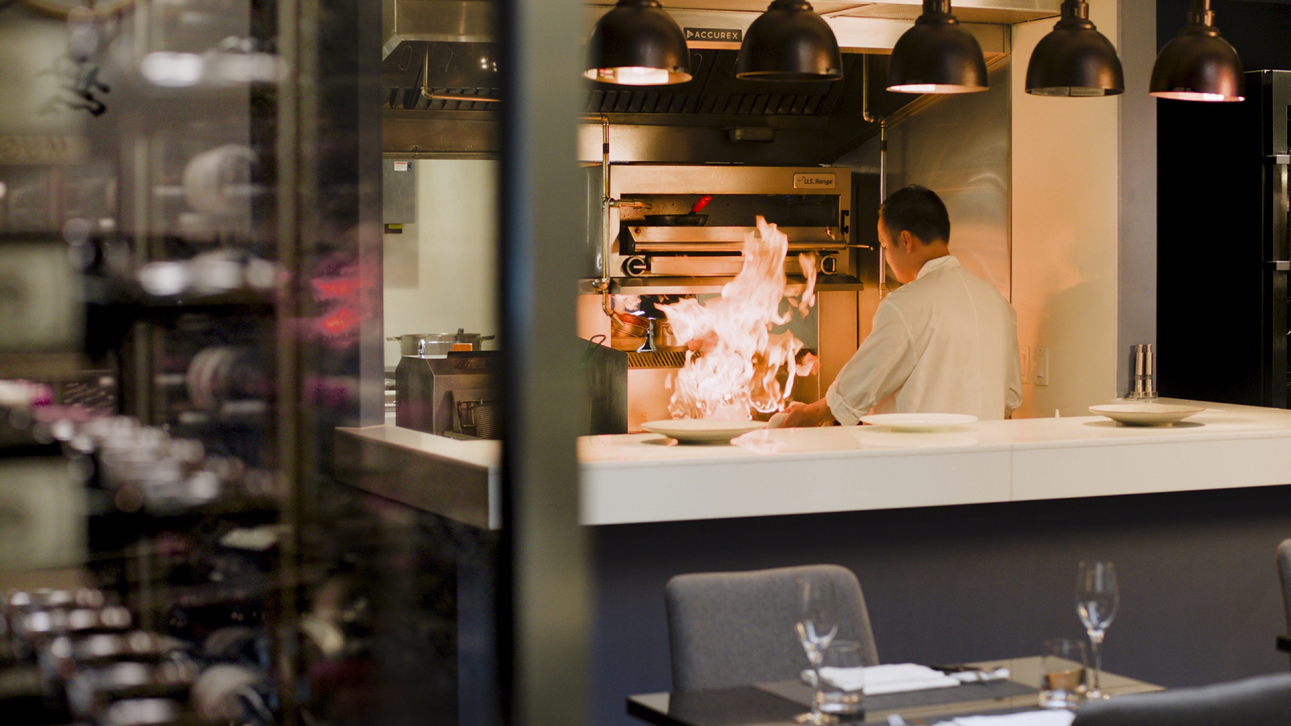 Chef Colin Sato working the flame in Mugen's open kitchen