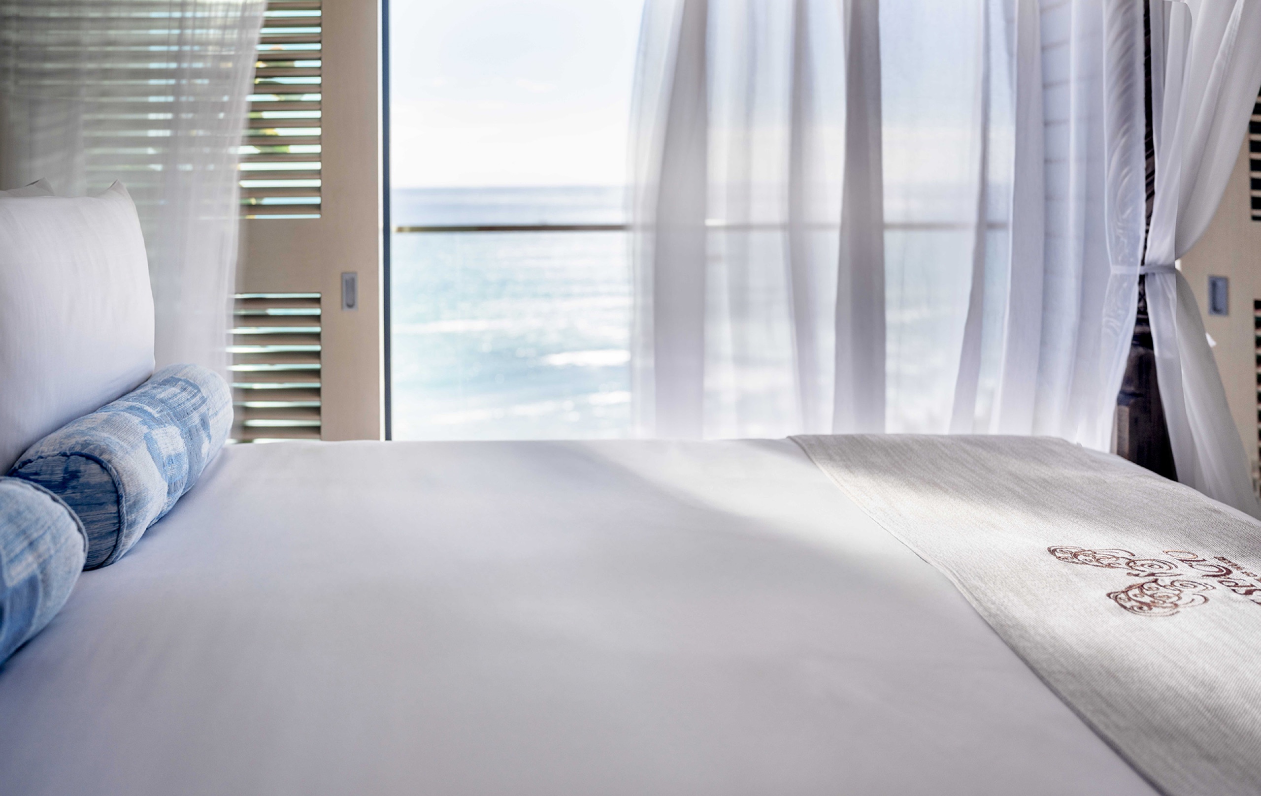 Primary bedroom - canopy king bed opening onto the private balcony and ocean