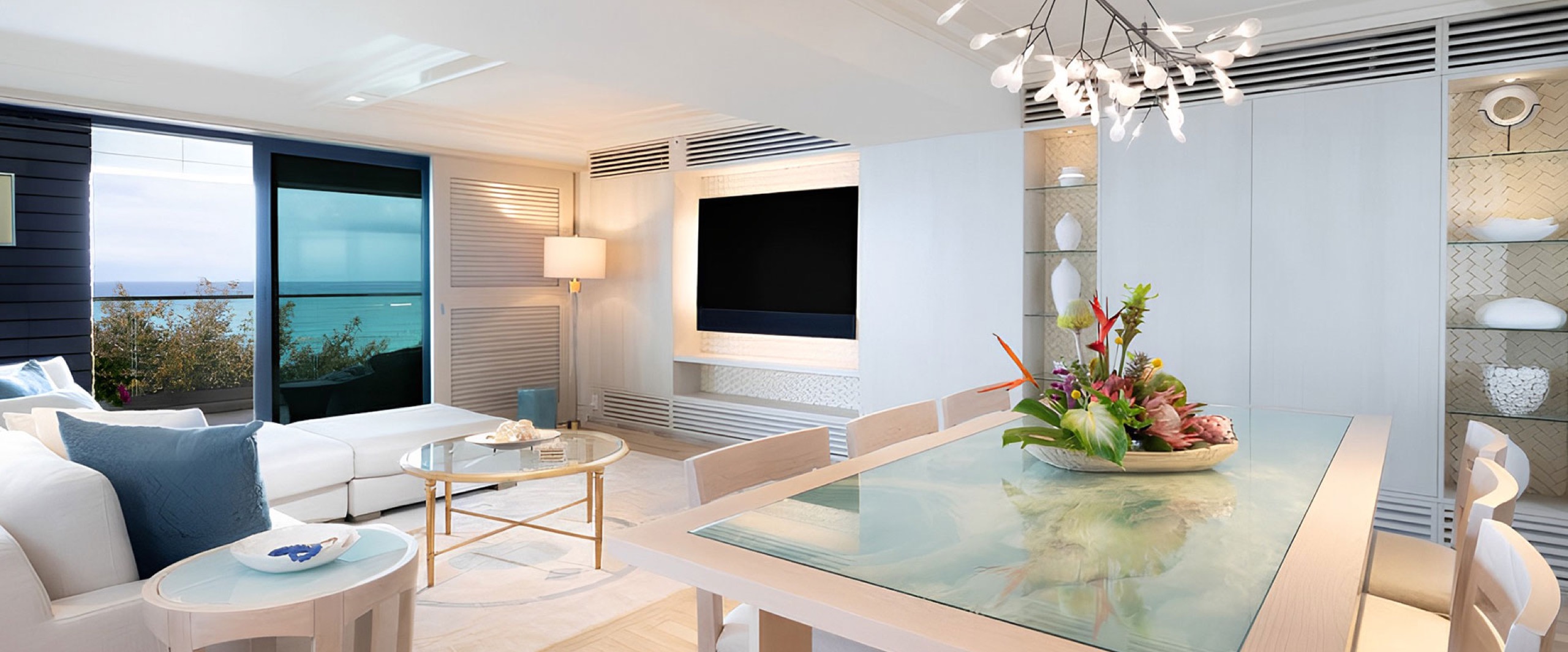 Oceanfront Suite great room - dining table and living area with ocean view (Sapphire / The Azul Suite tier)