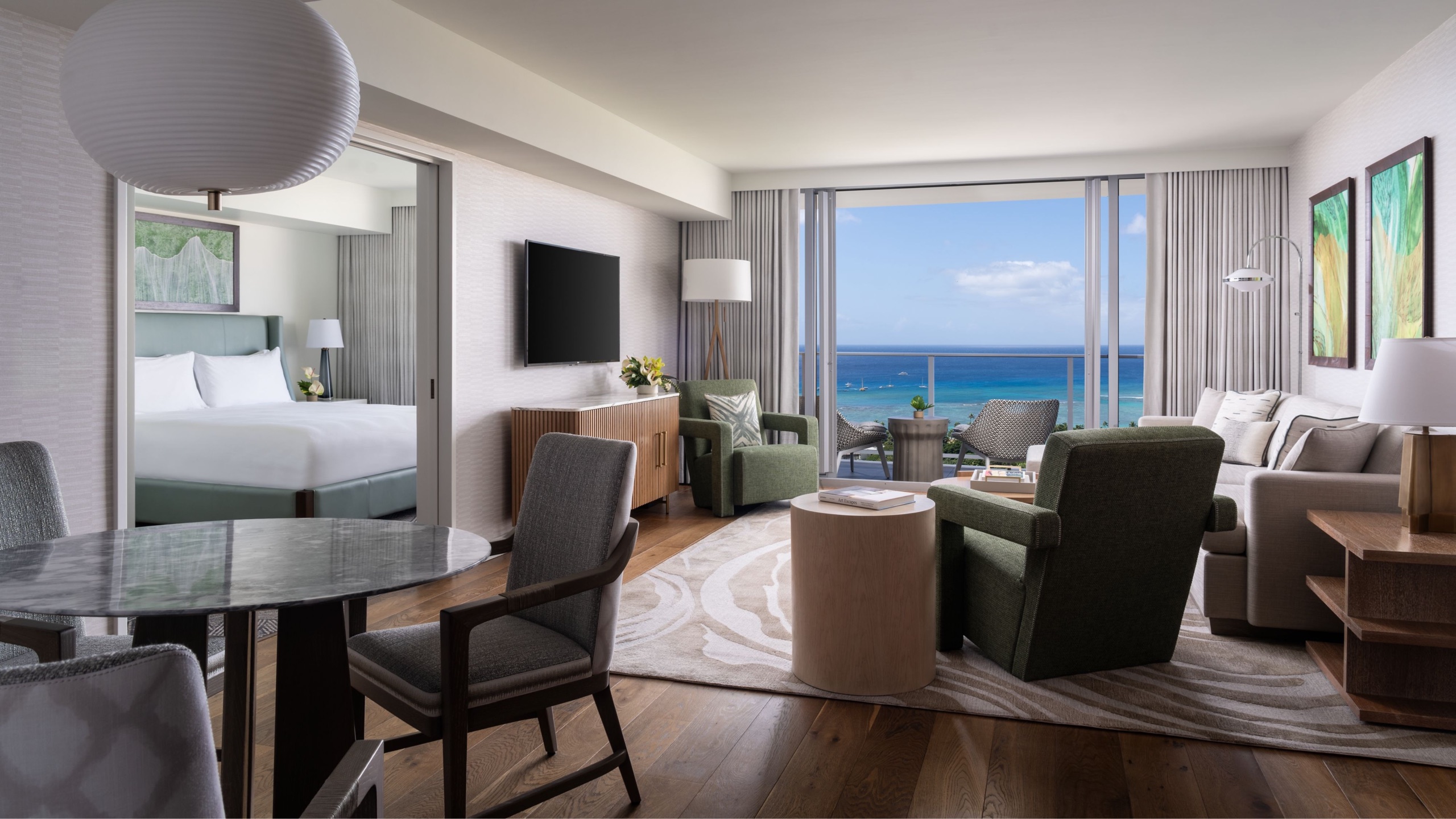 One Bedroom Ocean View Suite, living room with dining table and bedroom beyond