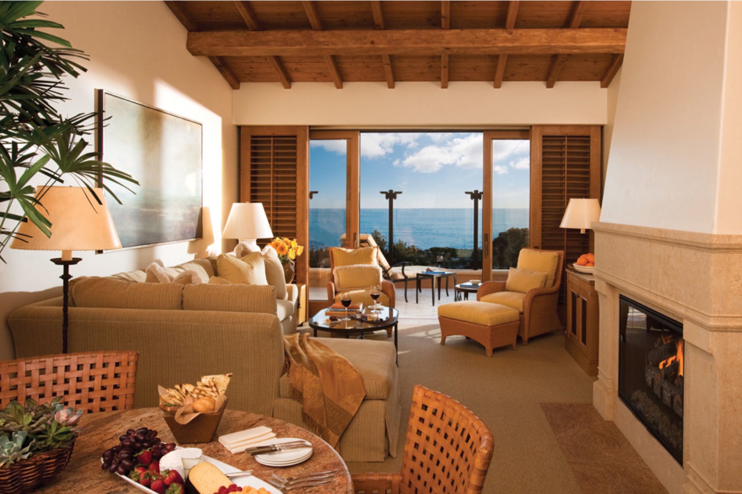 Ocean-View Bungalow Suite — separate living room with fireplace and ocean terrace