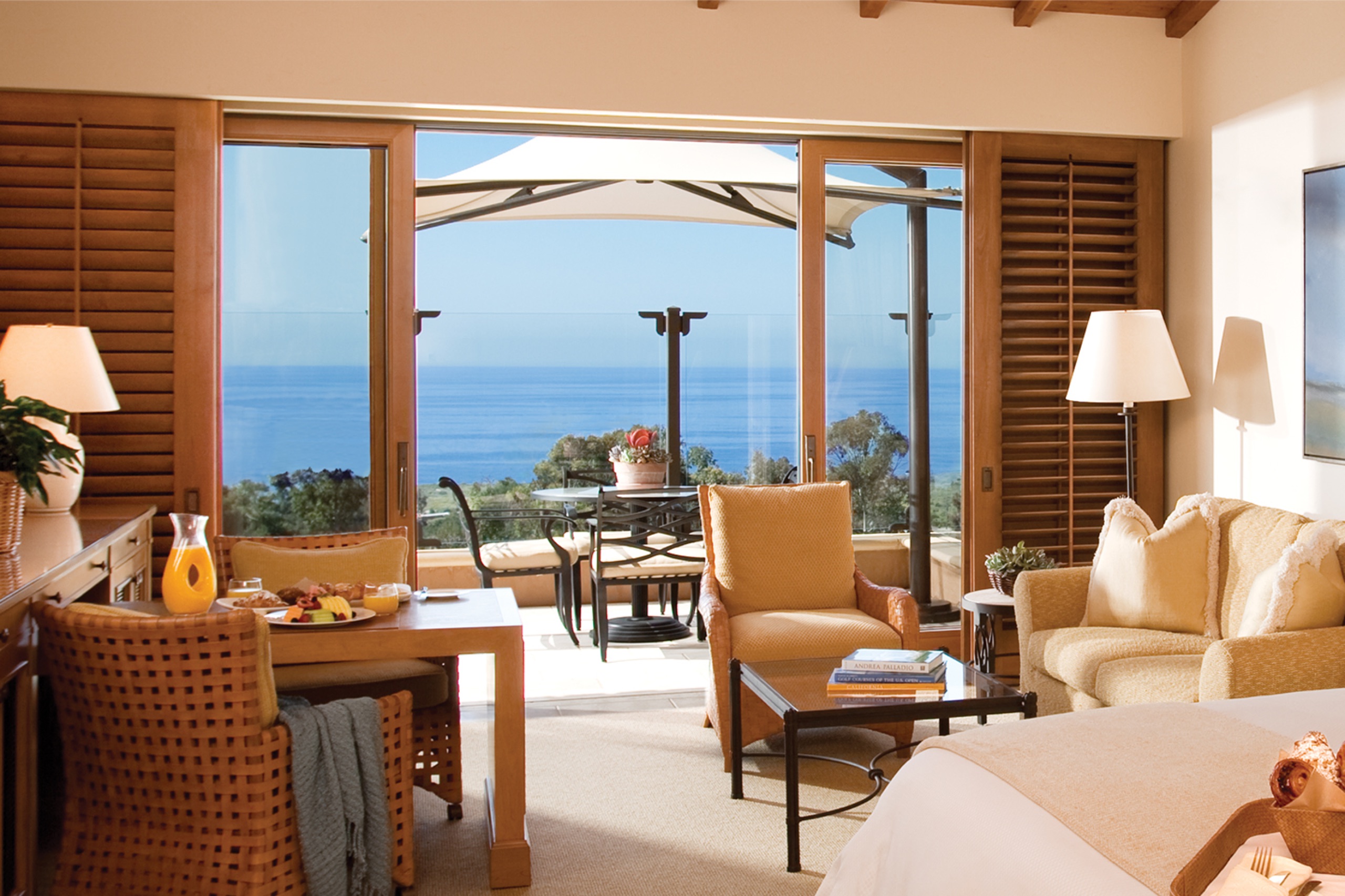 Ocean-View Bungalow Suite — bedroom side opening to the private terrace and ocean