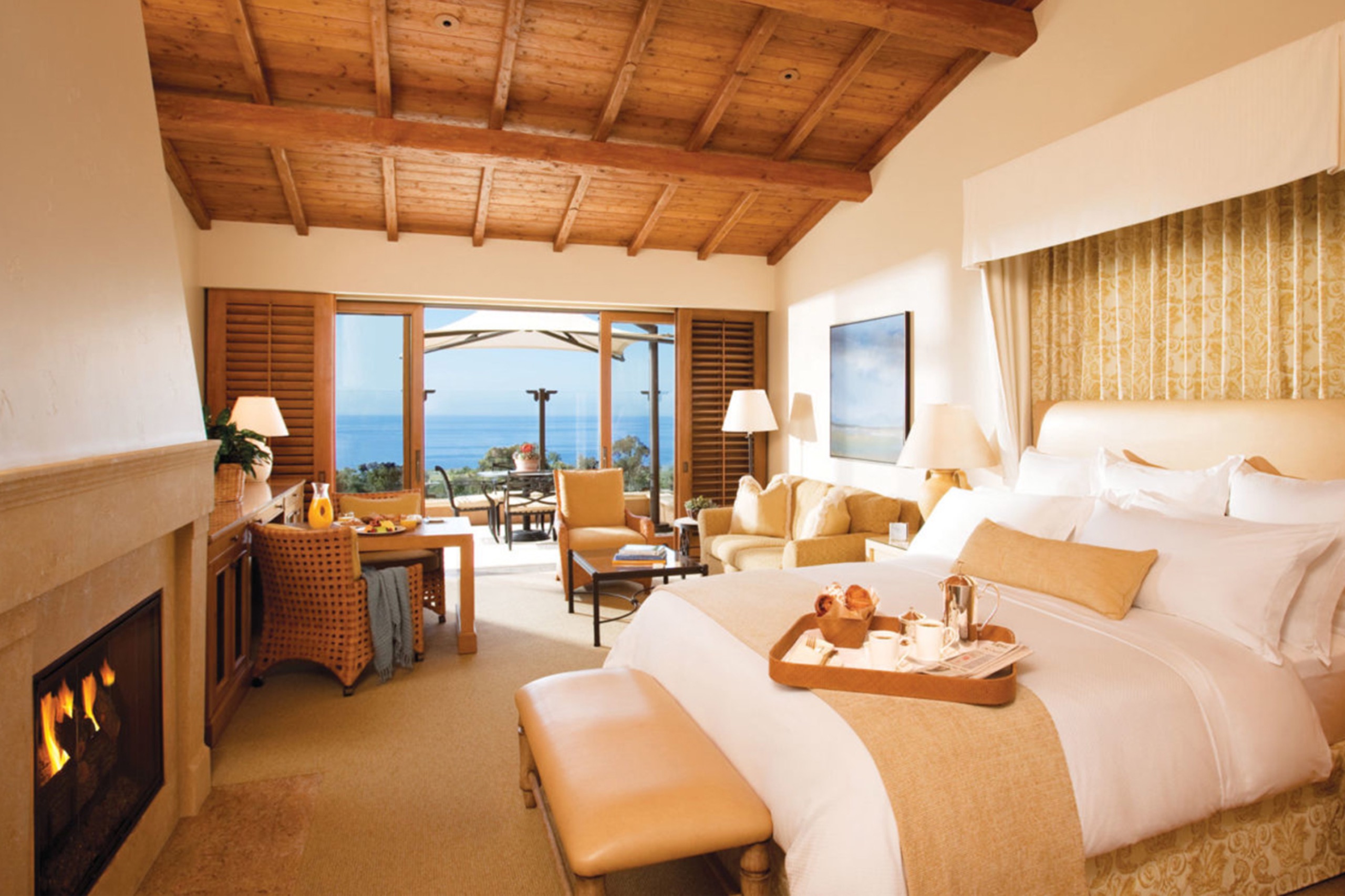 Ocean-View Bungalow — king bed, limestone fireplace, beamed ceiling, terrace to the Pacific