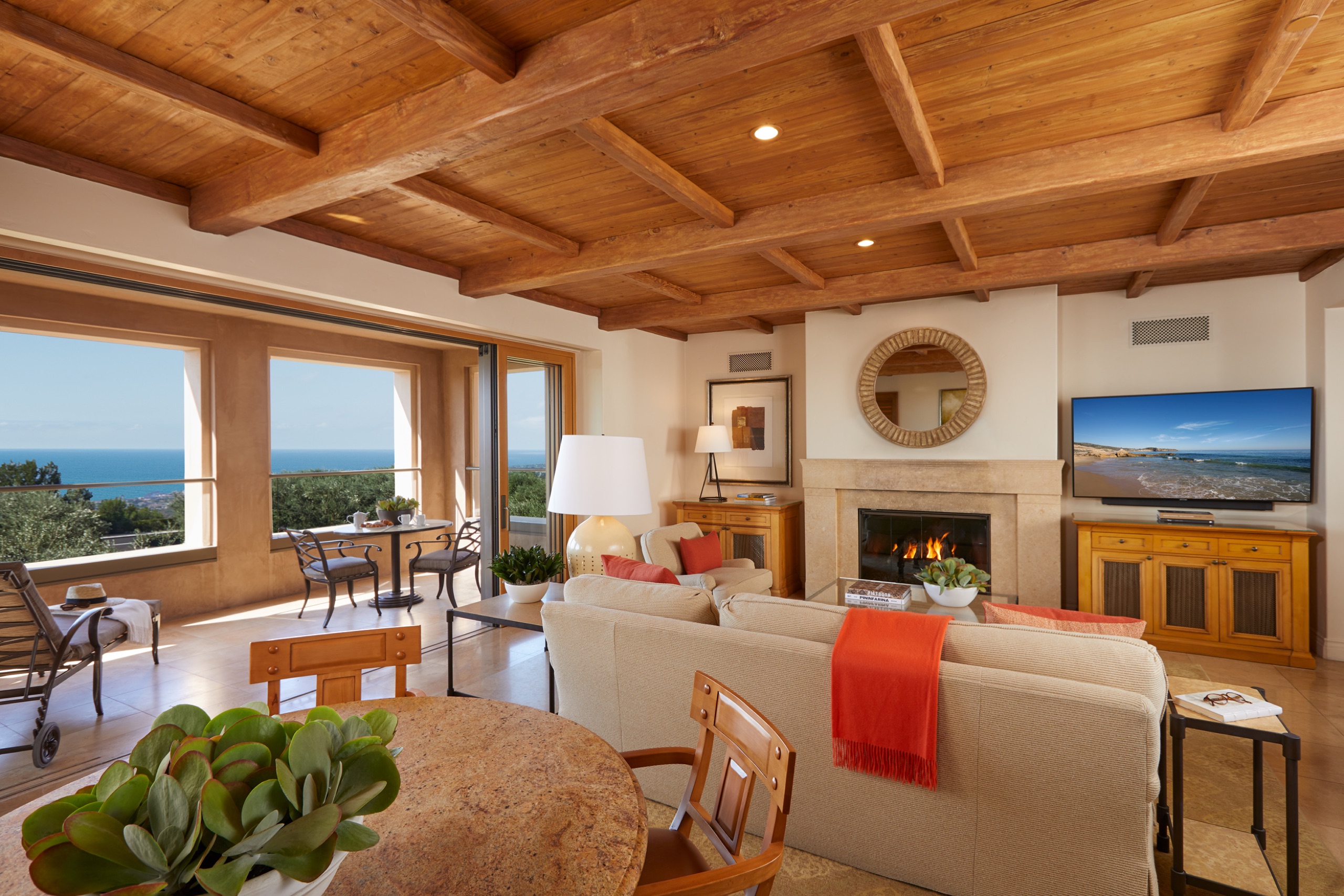 Two-Bedroom Villa — living room with ocean view, fireplace and beamed ceiling