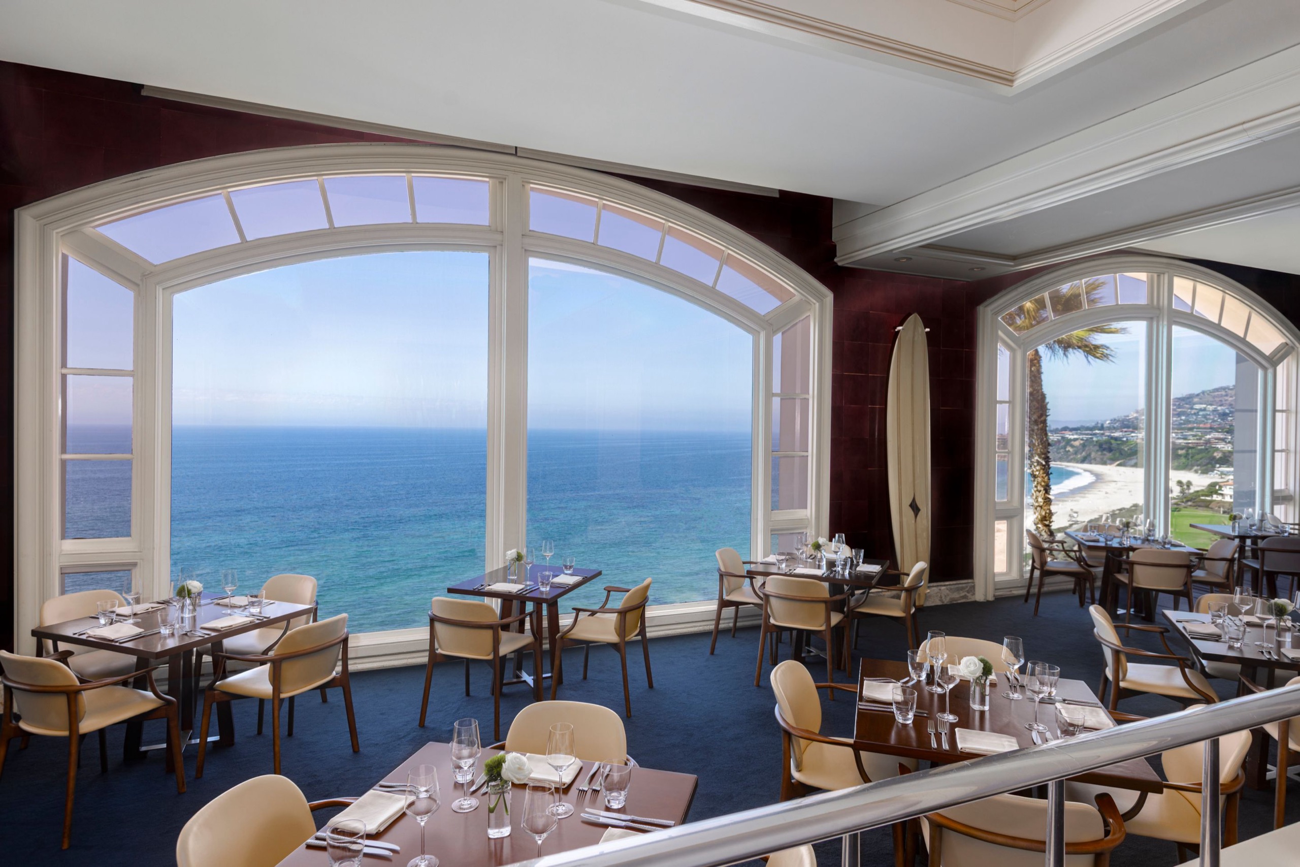 RAYA, coastal Latin seafood dining room with floor-to-ceiling arched windows over the Pacific