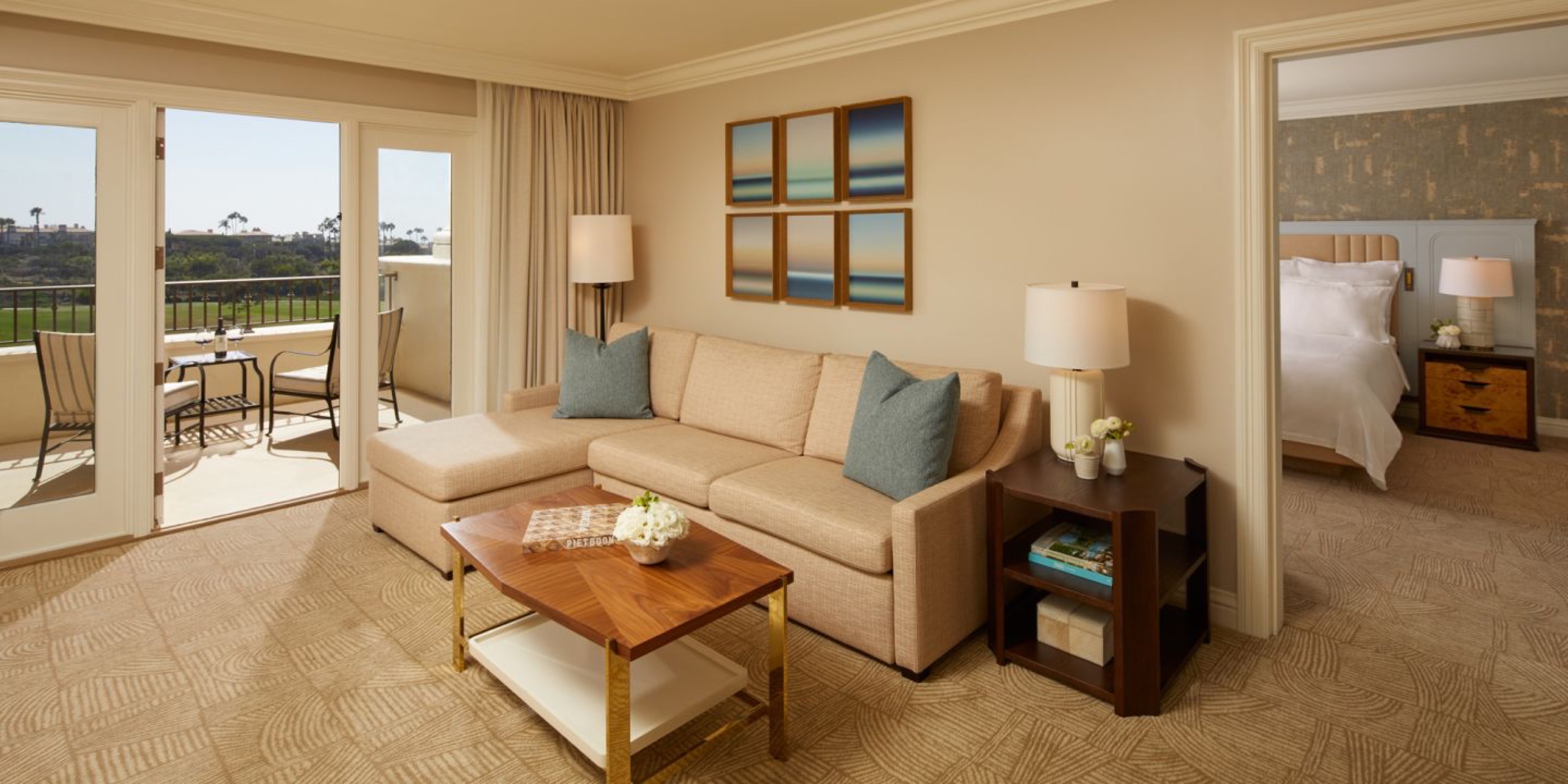 One-Bedroom Suite - living room with sectional, bedroom beyond, terrace