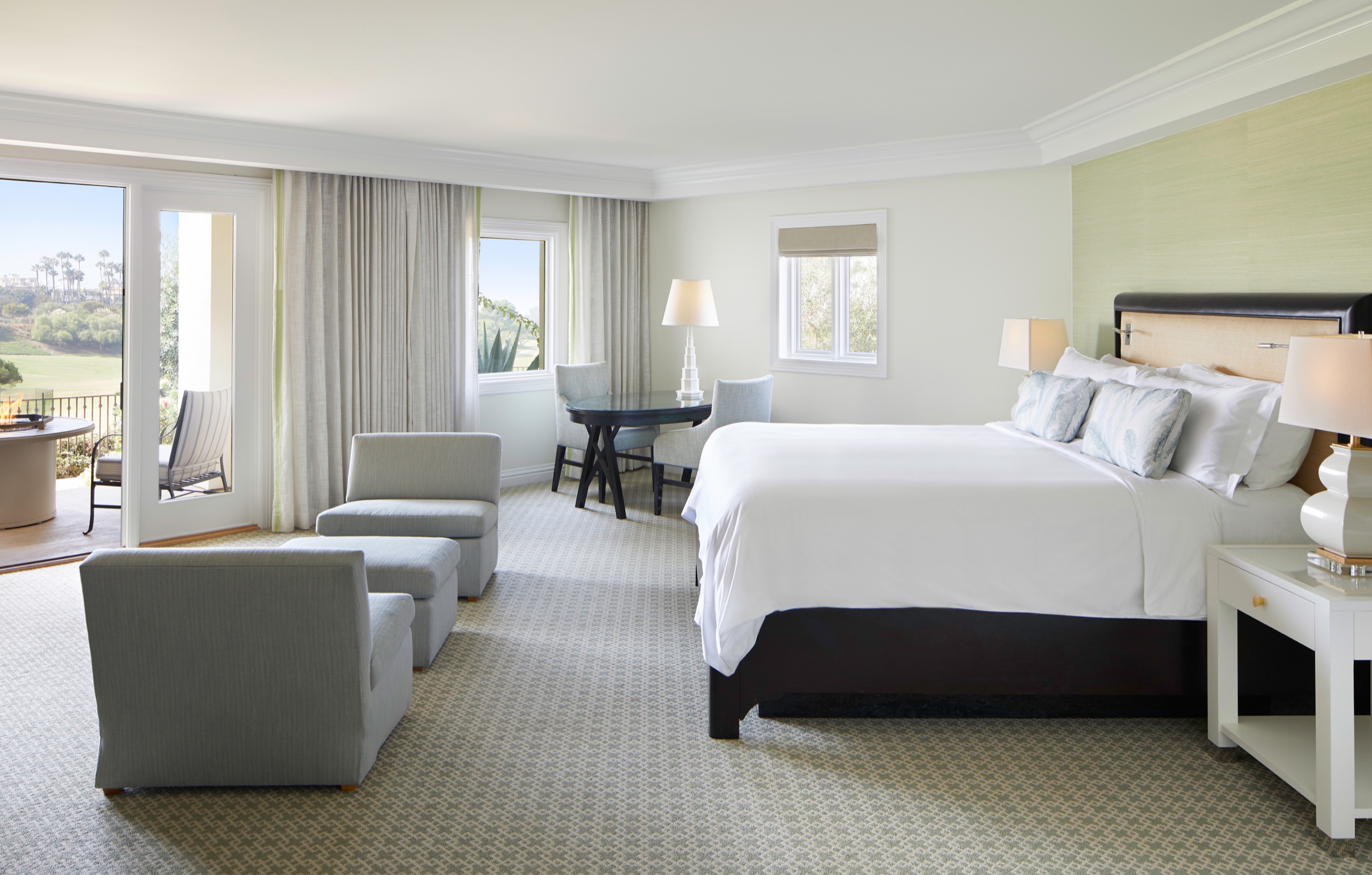 Suite bedroom - king bed, seating area and terrace over the golf course
