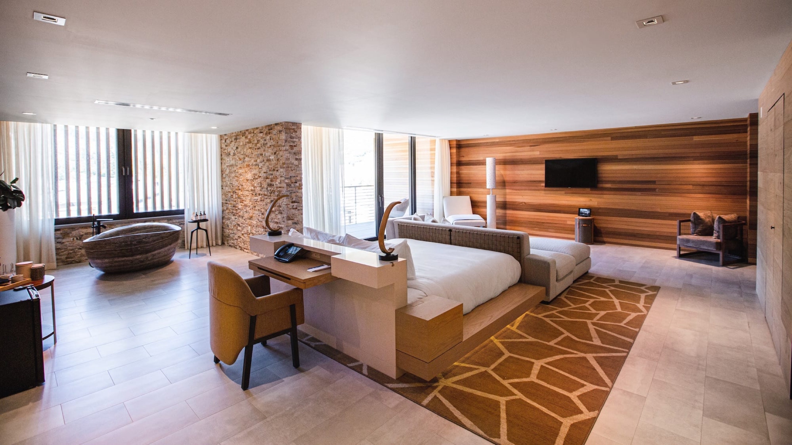 Peregrine Suite - living room with sectional and hillside view