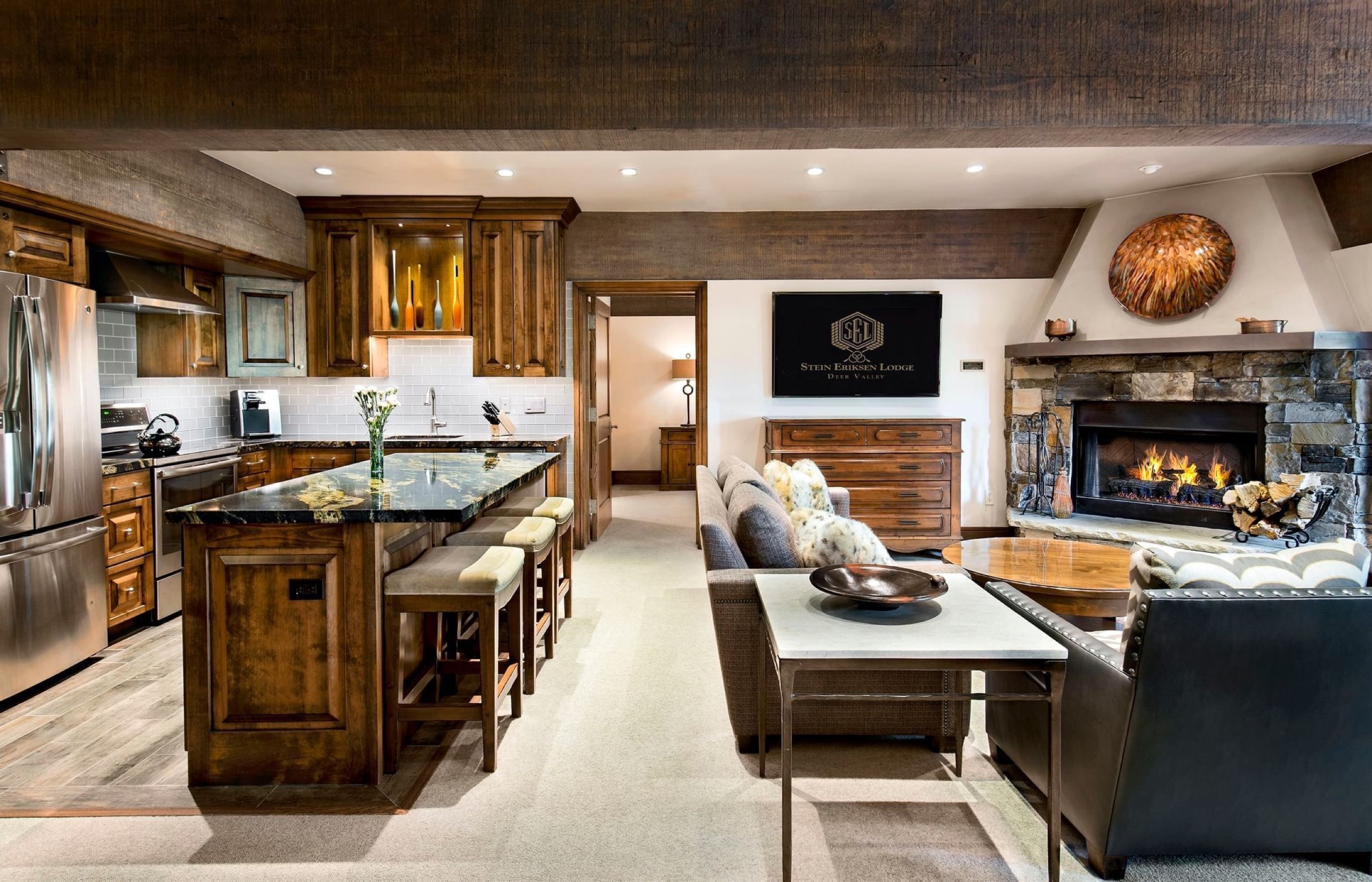 Luxury Suite kitchen and living room with stone fireplace (suite 172-1)