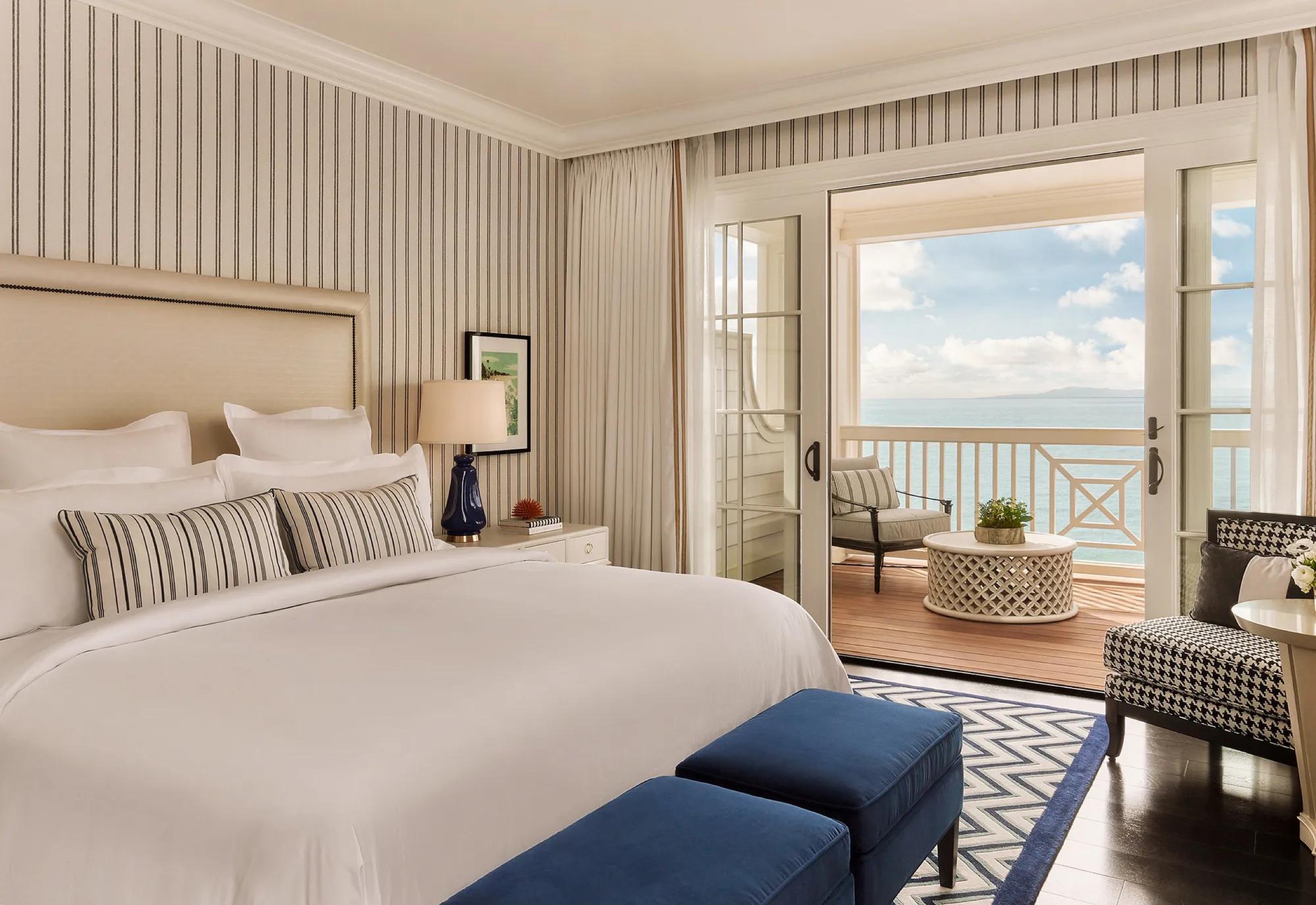 Beach House King guestroom opening onto an oceanfront terrace