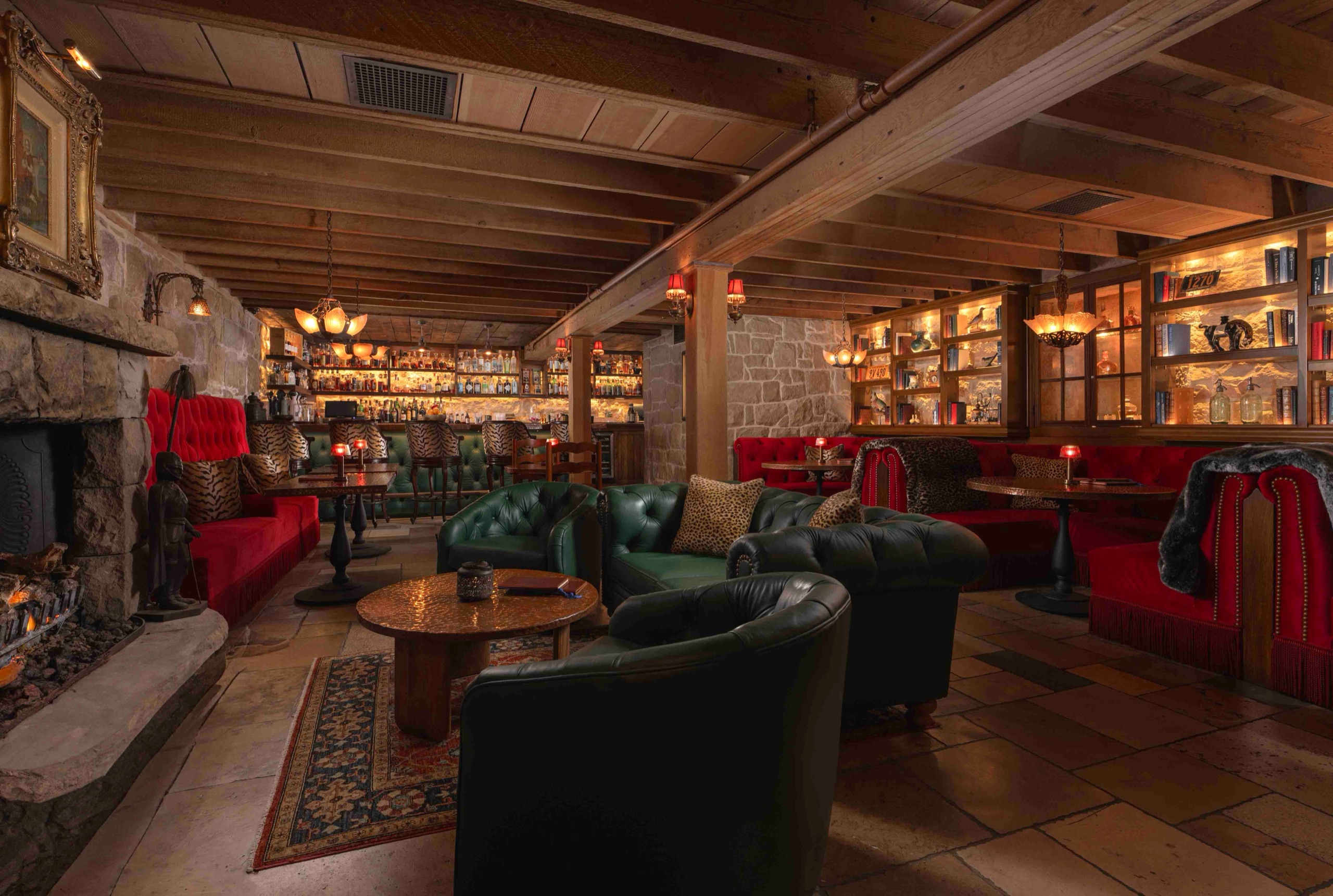 The Speakeasy at Plow & Angel - stone-walled lounge with tufted leather seating