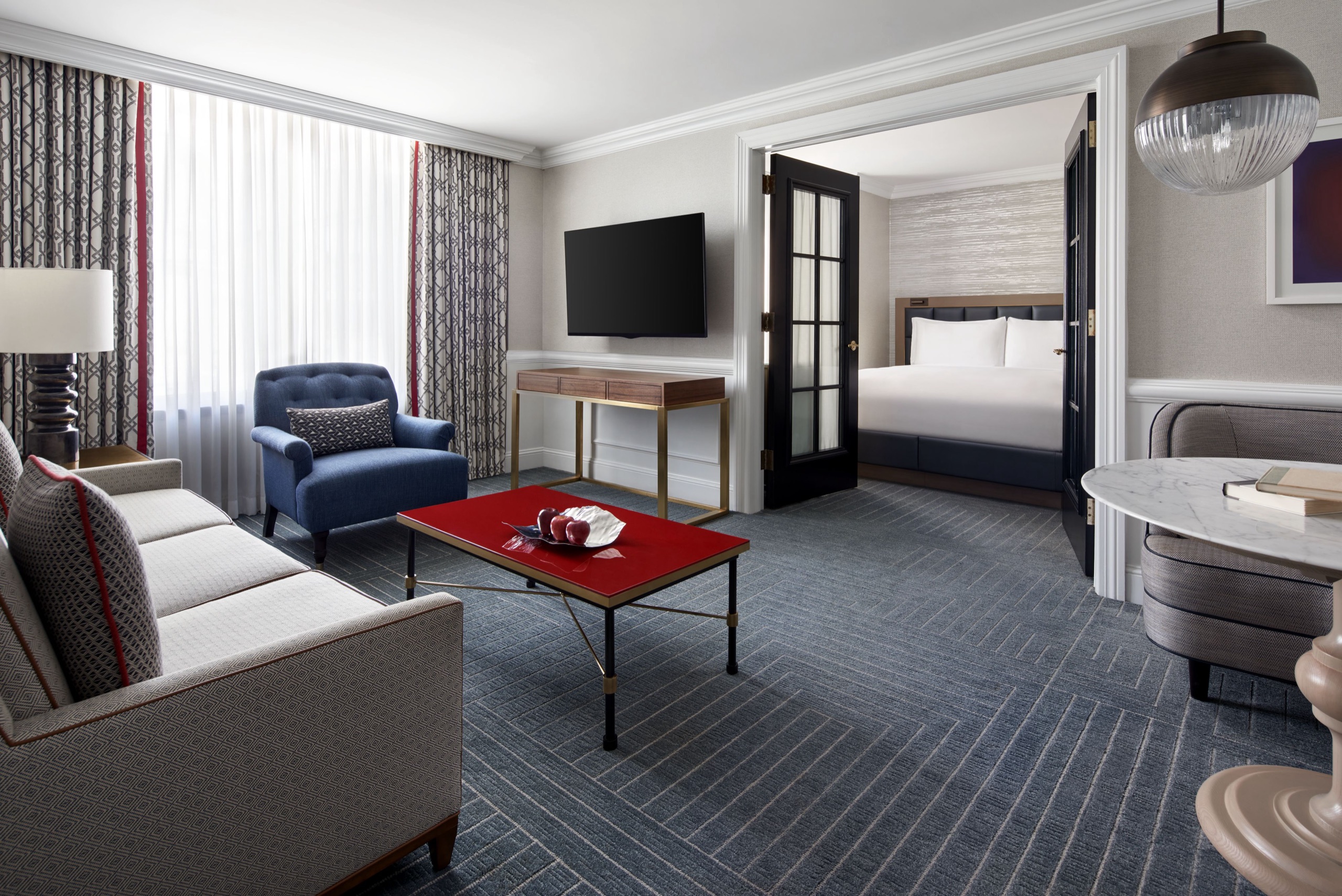 Executive Suite — living room with view into bedroom